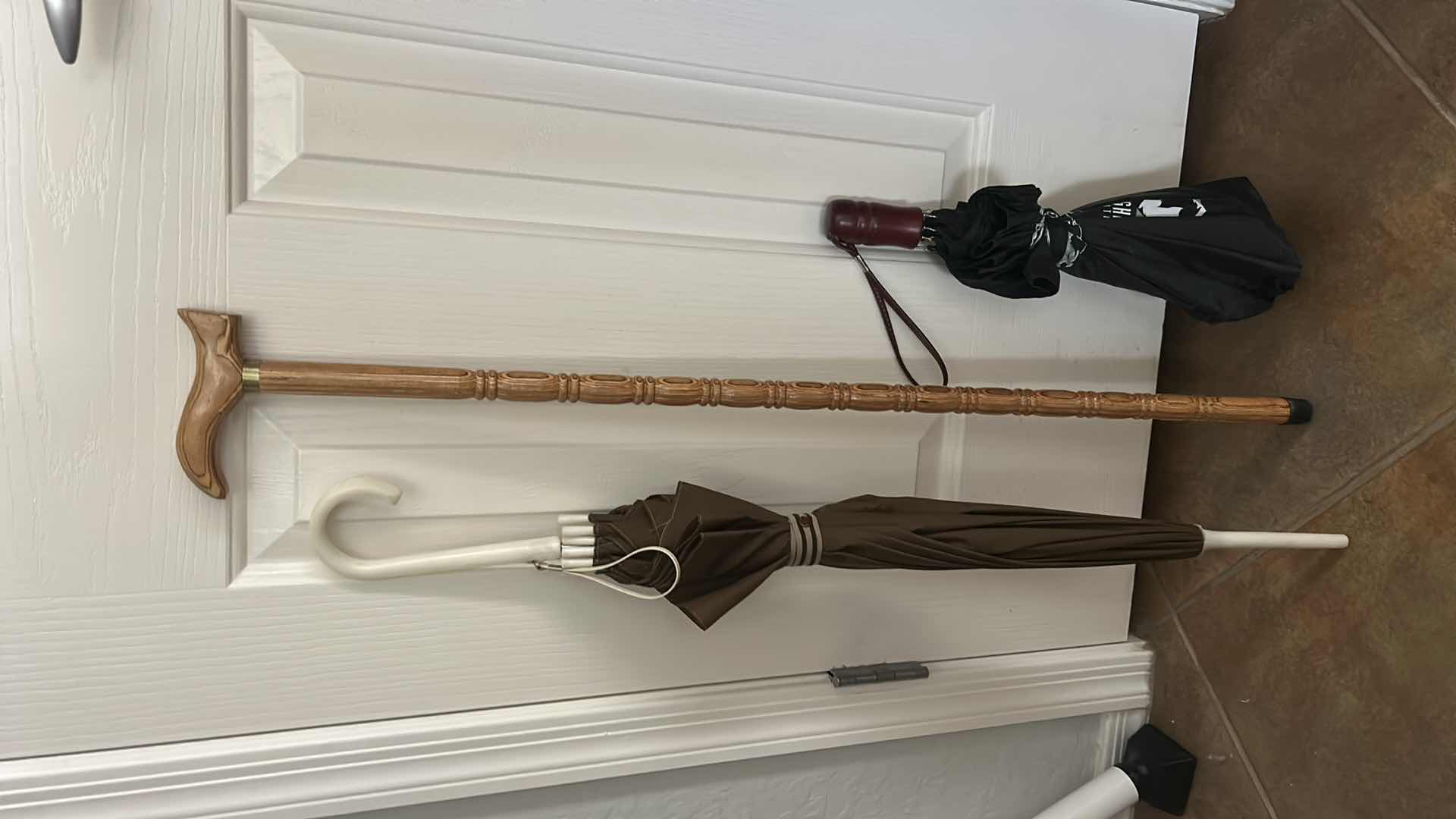 Photo 1 of WOOD CANE AND 2 UMBRELLAS