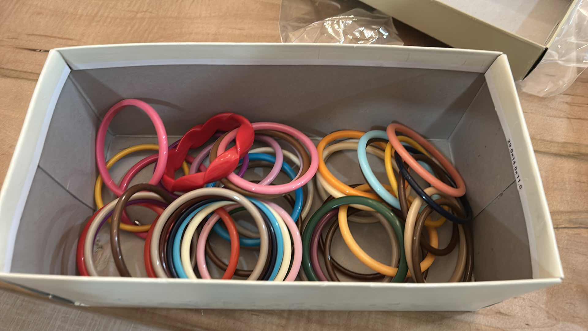 Photo 1 of BOX OF MULTICOLORED BRACELETS