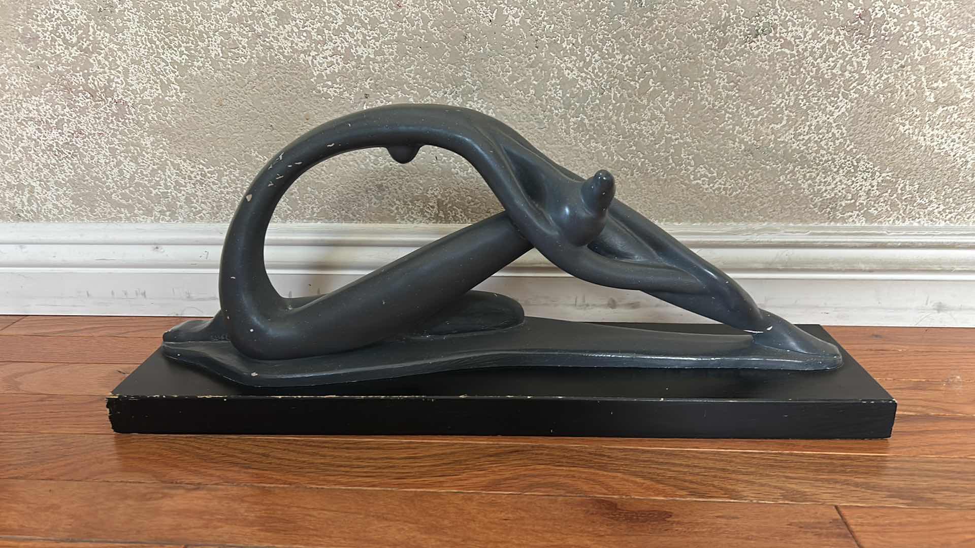 Photo 1 of VINTAGE 1970’S “STRETCHING DANCER”, ABSTRACT SCULPTURE BY AUSTIN PRODUCTIONS INC. DESIGNED BY ARTIST CLARA SEVER CRAFTED FROM PLASTER WITH A MATTE BLACK FINISH, MOUNTED ON A WOOD BASE . 23” x 5 1/2“ x H8“