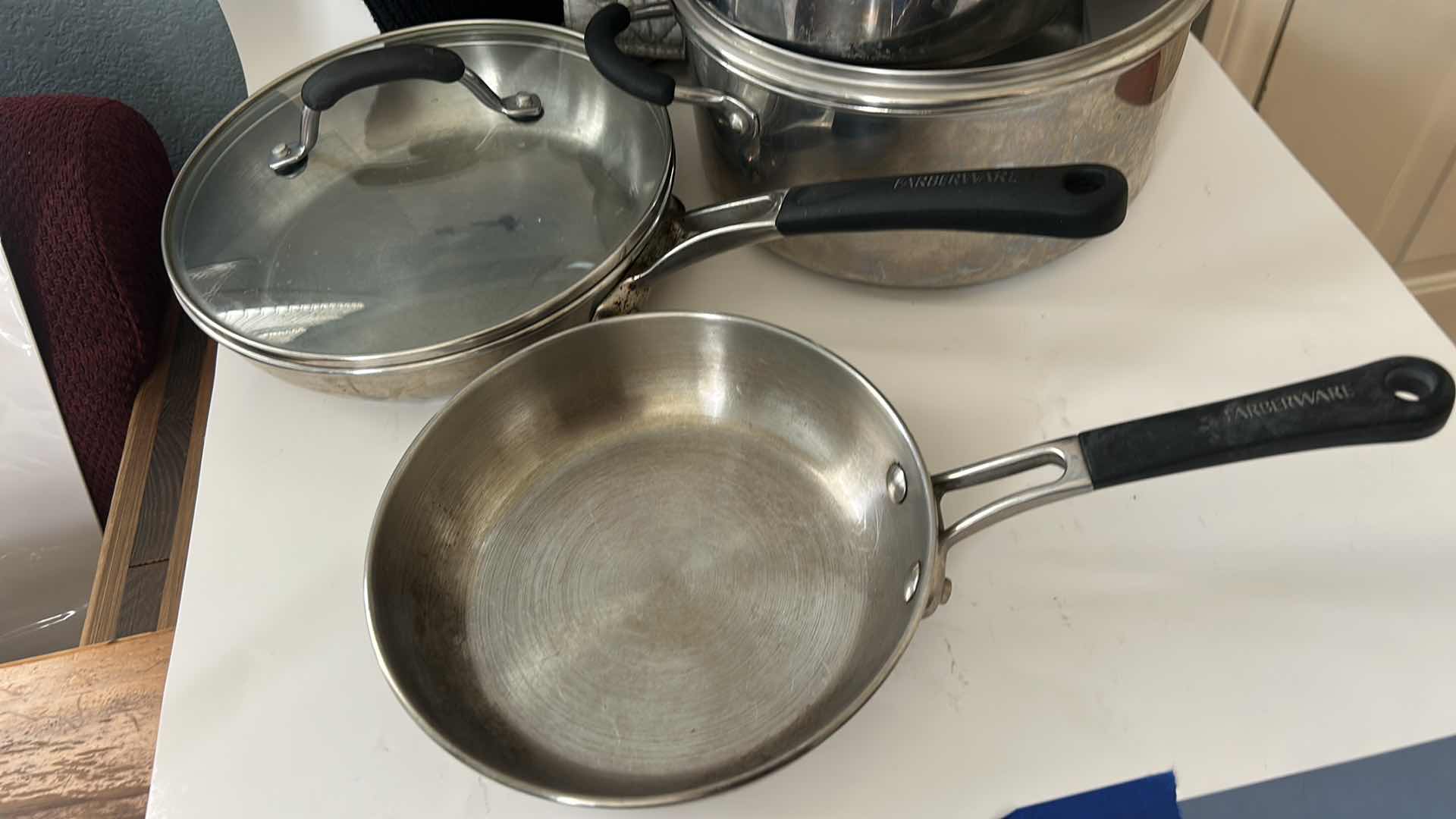 Photo 1 of FARBERWARE POTS AND PANS WITH LIDS AND OVEN MITTS