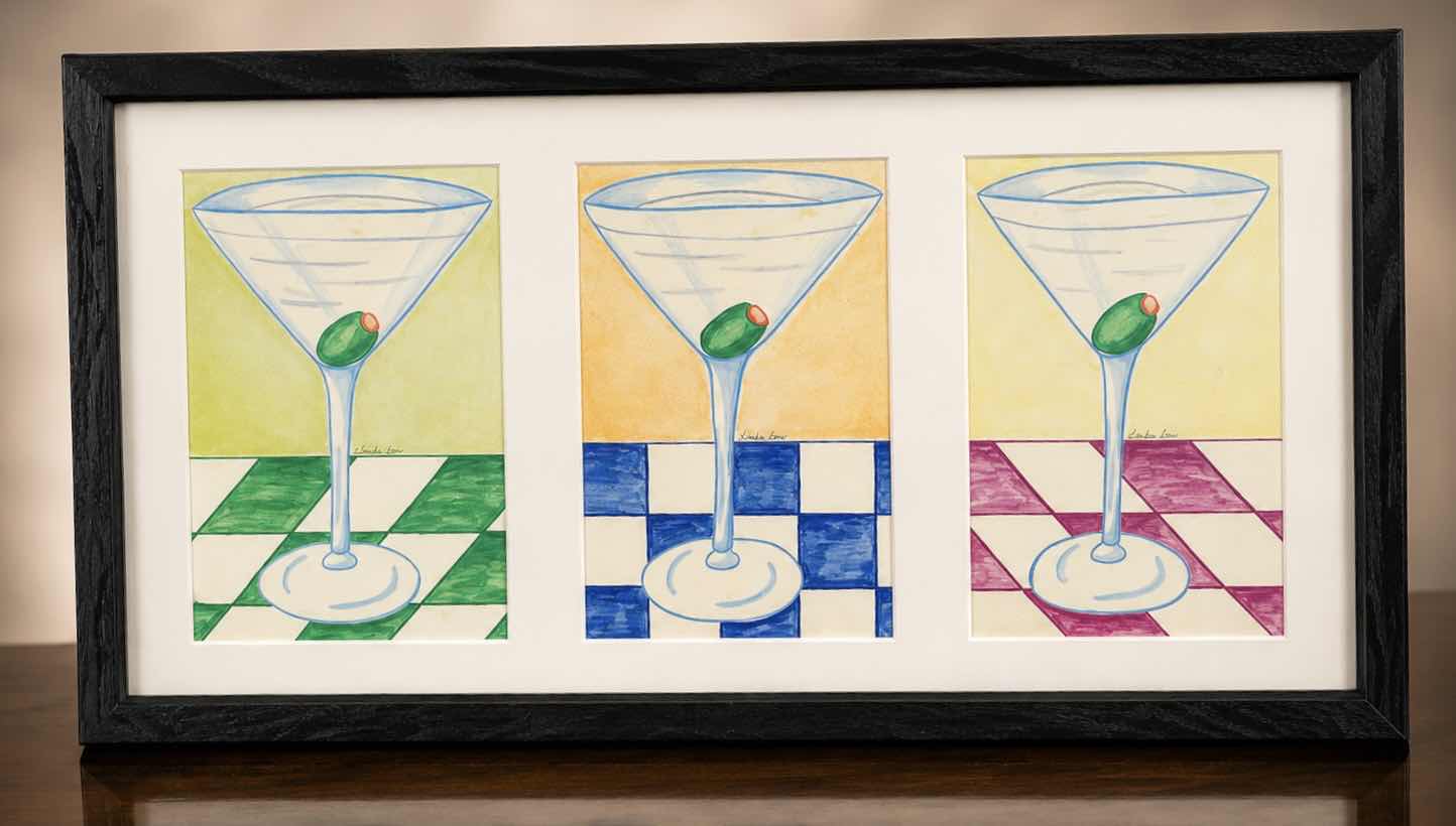 Photo 1 of FRAMED SIGNED ARTWORK FEATURING A WHIMSICAL ILLUSTRATION OF 3 CLASSIC MARTINI GLASSES WITH GREEN PIMENTO STUFFED OLIVES 21” x 11 1/4”