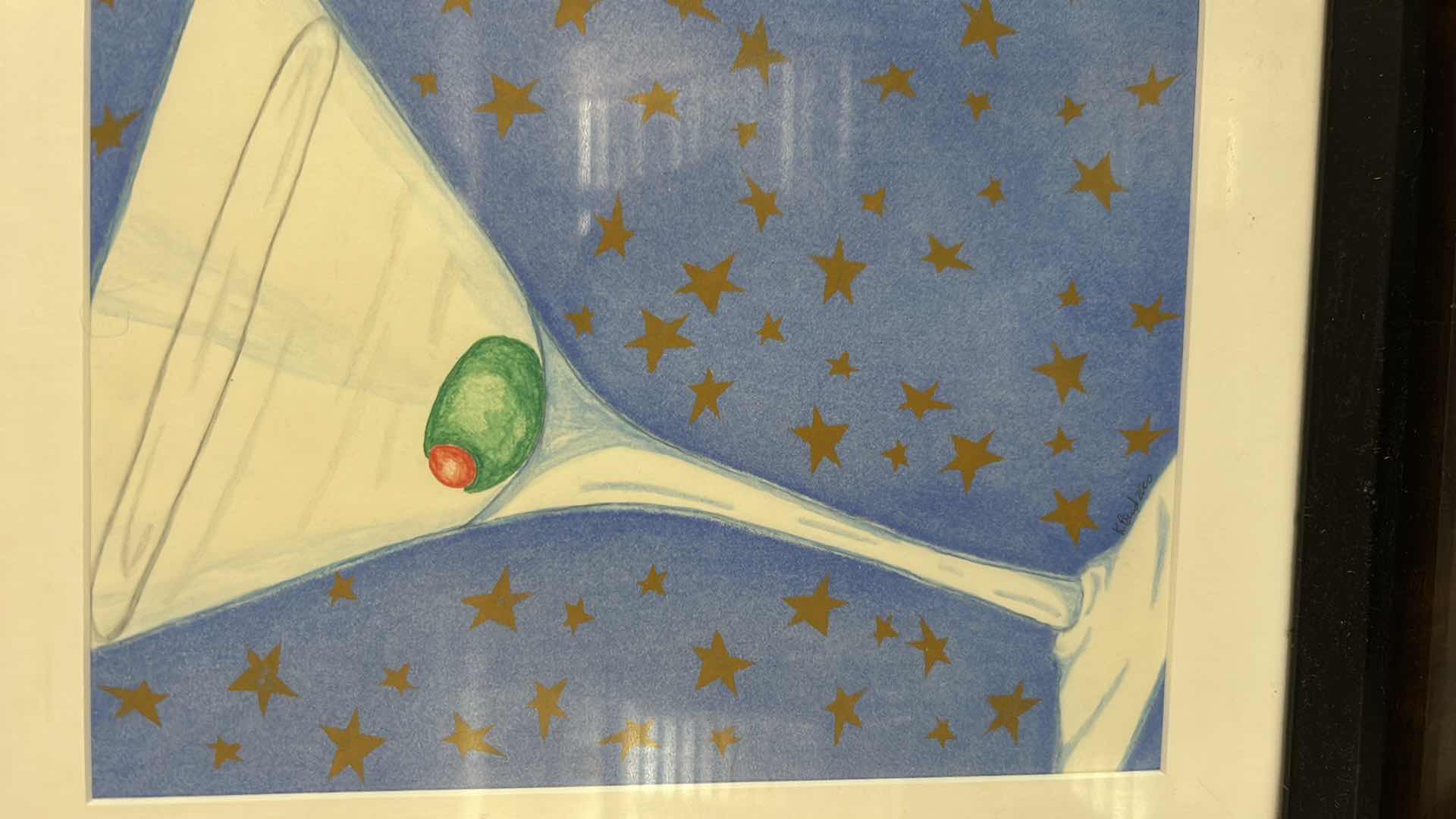 Photo 1 of FRAMED SIGNED ARTWORK FEATURING A WHIMSICAL ILLUSTRATION OF A CLASSIC MARTINI GLASS WITH A GREEN PIMENTO STUFFED OLIVE 12 1/4” x H15 1/4”