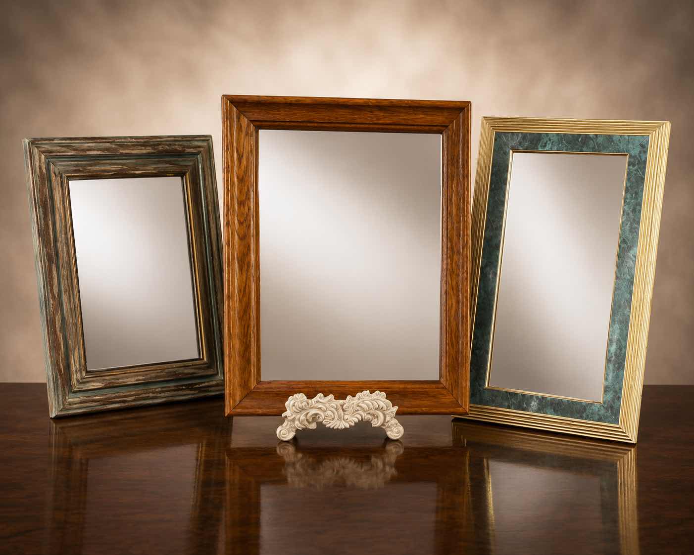 Photo 1 of THREE FRAMED WALL MIRRORS. (TALLEST H19”)
