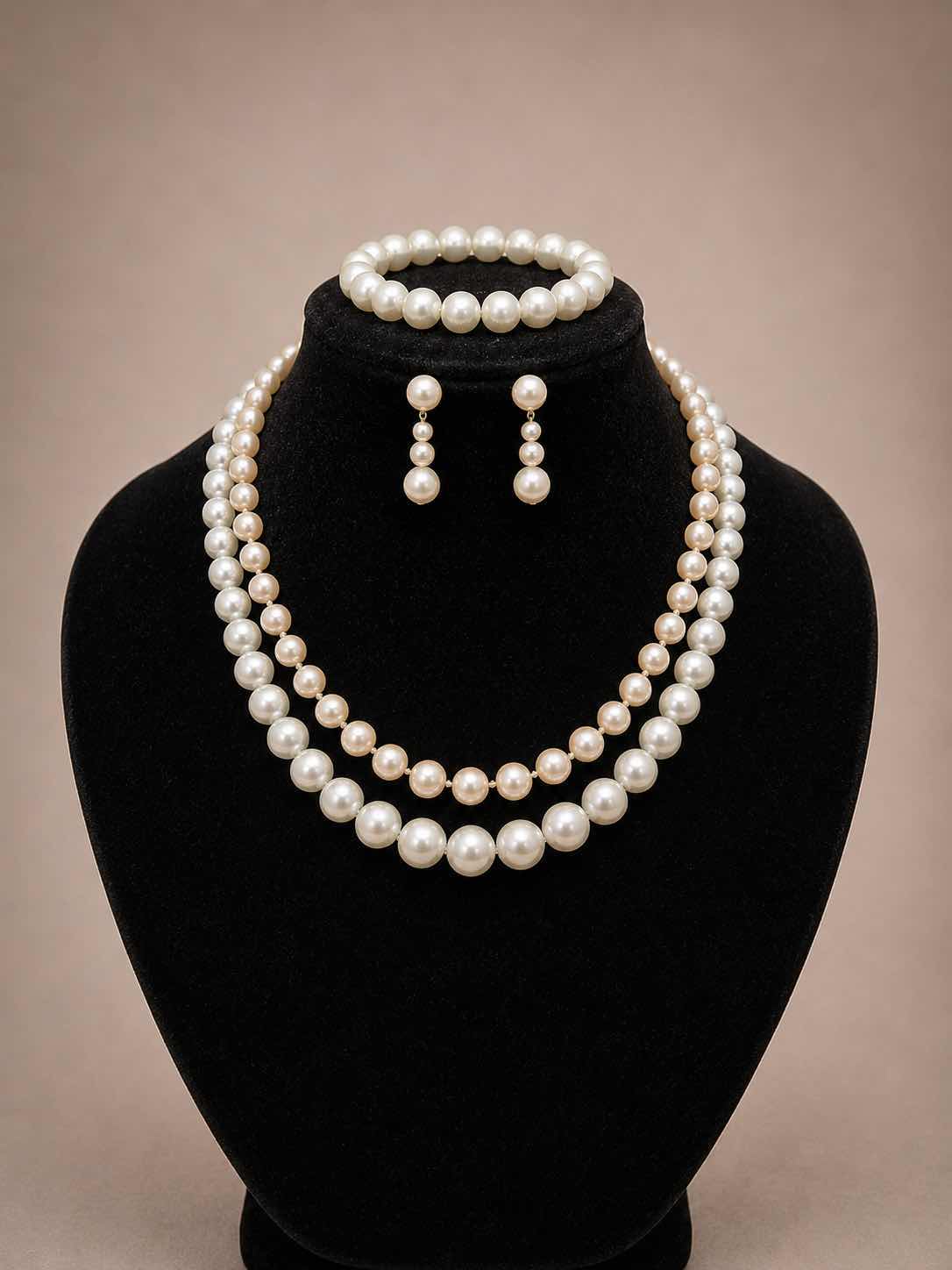 View 1 of VINTAGE FAUX PEARL SET WITH LAYERED NECKLACES, EARRINGS, AND BRACELET.