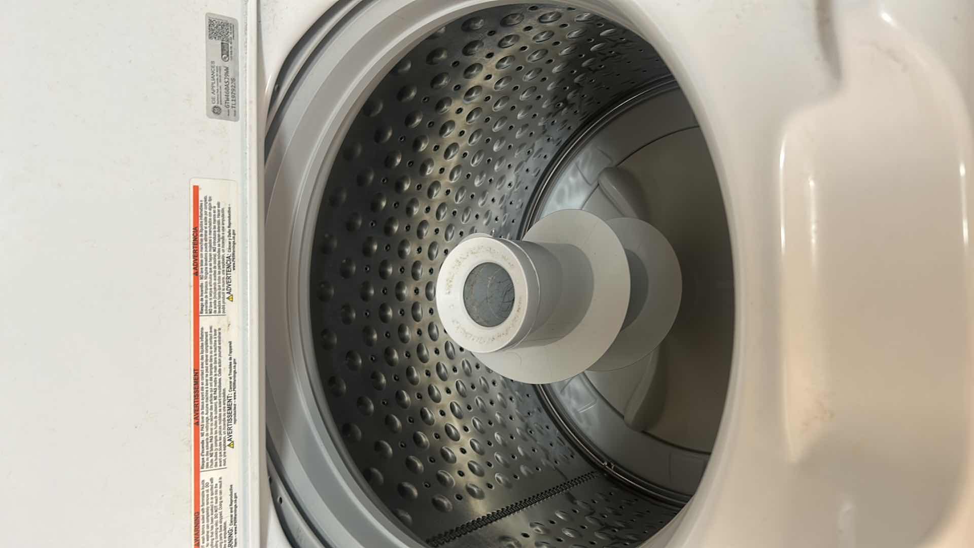 Photo 1 of WHITE GE TOP LOAD WASHER W 4.5 CUBIC FOOT CAPACITY AND STAINLESS STEEL BASKET 27" X 27" H 44"