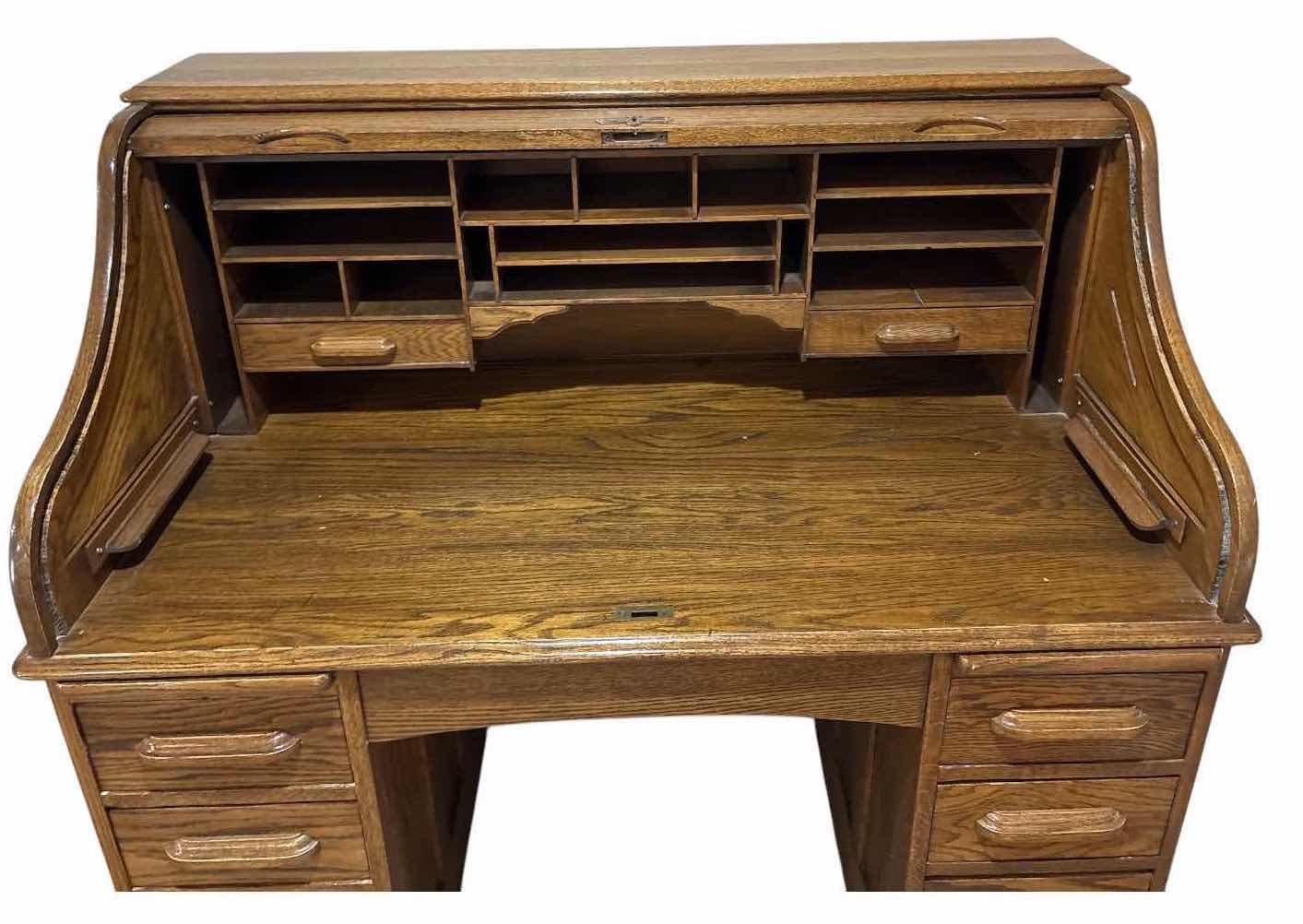 View 2 of SOLID OAK ROLL TOP DESK W 8 STORAGE DRAWERS, CENTER KNEEHOLE, AND LOCKABLE ROLL-TOP COVER (KEY NOT INCLUDED) 49”X29”H47.5” $900