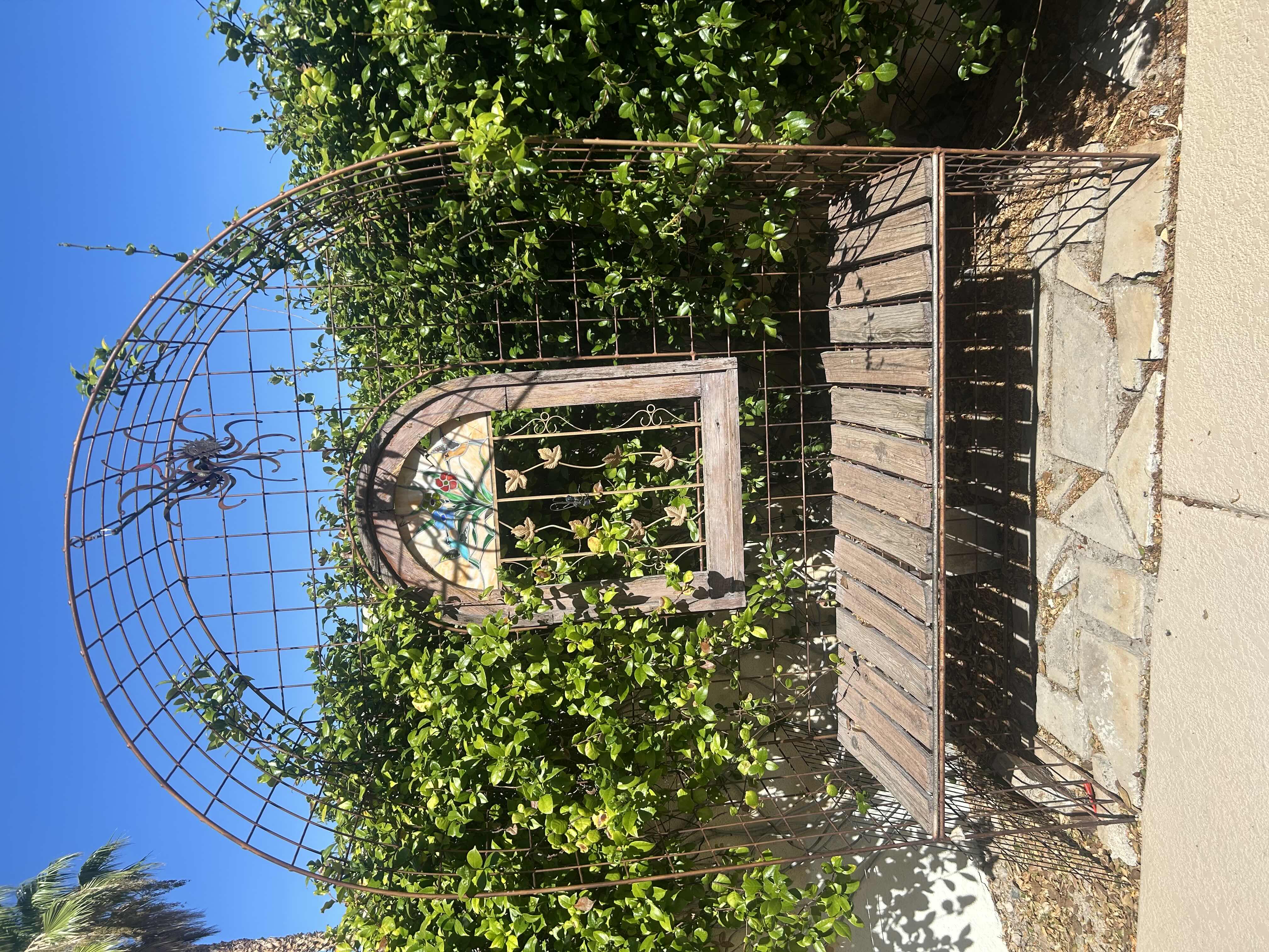 Photo 1 of RUSTED METAL ARBOR BENCH W WOODEN SLAT SEAT