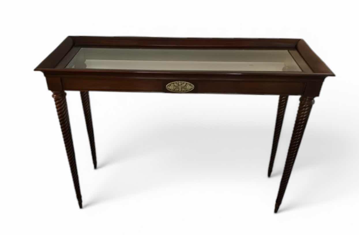 Photo 1 of DARK WOOD SOFA TABLE WITH GLASS TOP, TWISTED LEGS AND BRASS-TONE ACCENT PLAQUE 45“ x 17“ x H31 1/2“