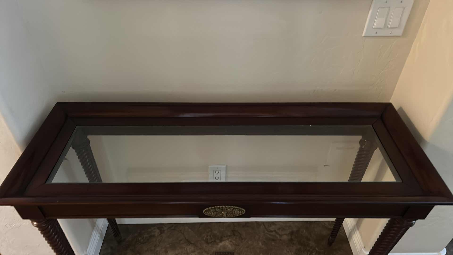 Photo 1 of DARK WOOD SOFA TABLE WITH GLASS TOP, TWISTED LEGS AND BRASS-TONE ACCENT PLAQUE 45“ x 17“ x H31 1/2“