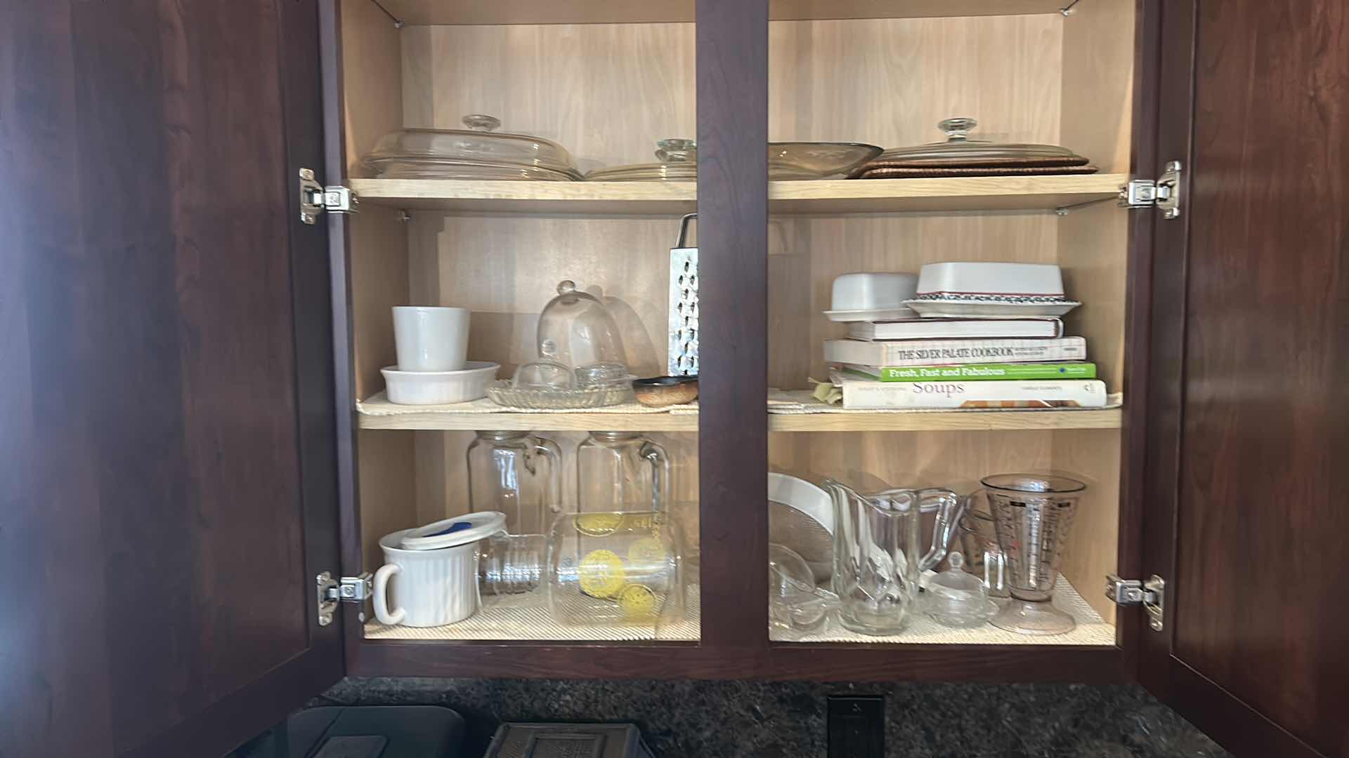 Photo 1 of CONTENTS IN KITCHEN CABINET- PITCHERS, COOKBOOKS, MEASURING CUPS AND MORE