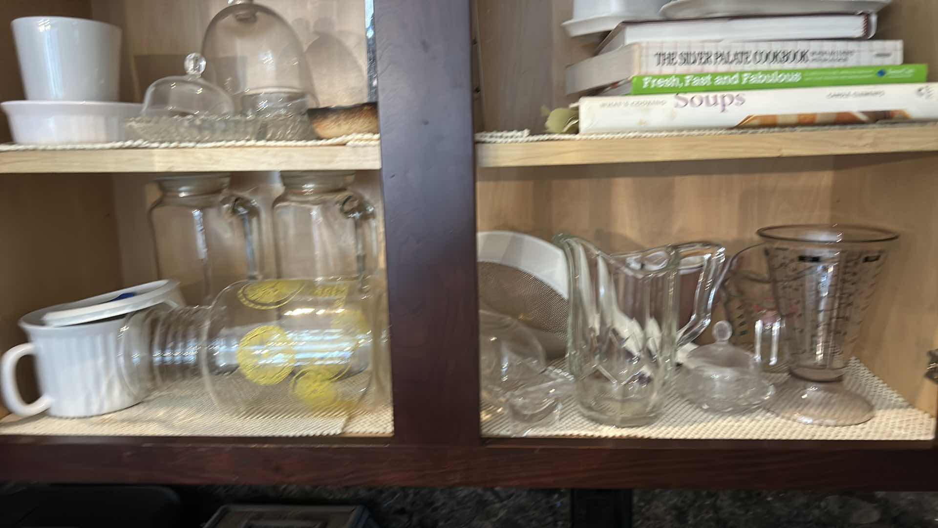 Photo 1 of CONTENTS IN KITCHEN CABINET- PITCHERS, COOKBOOKS, MEASURING CUPS AND MORE
