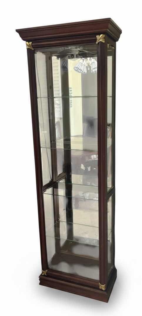 Photo 1 of VICTORIAN STYLE, LIGHTED CHERRY CURIO CABINET FEATURING GOLD-ACCENTED CORNER DETAILS AND A SLIDING DOOR. 25 1/4“ x 12 1/2“ x H76“.