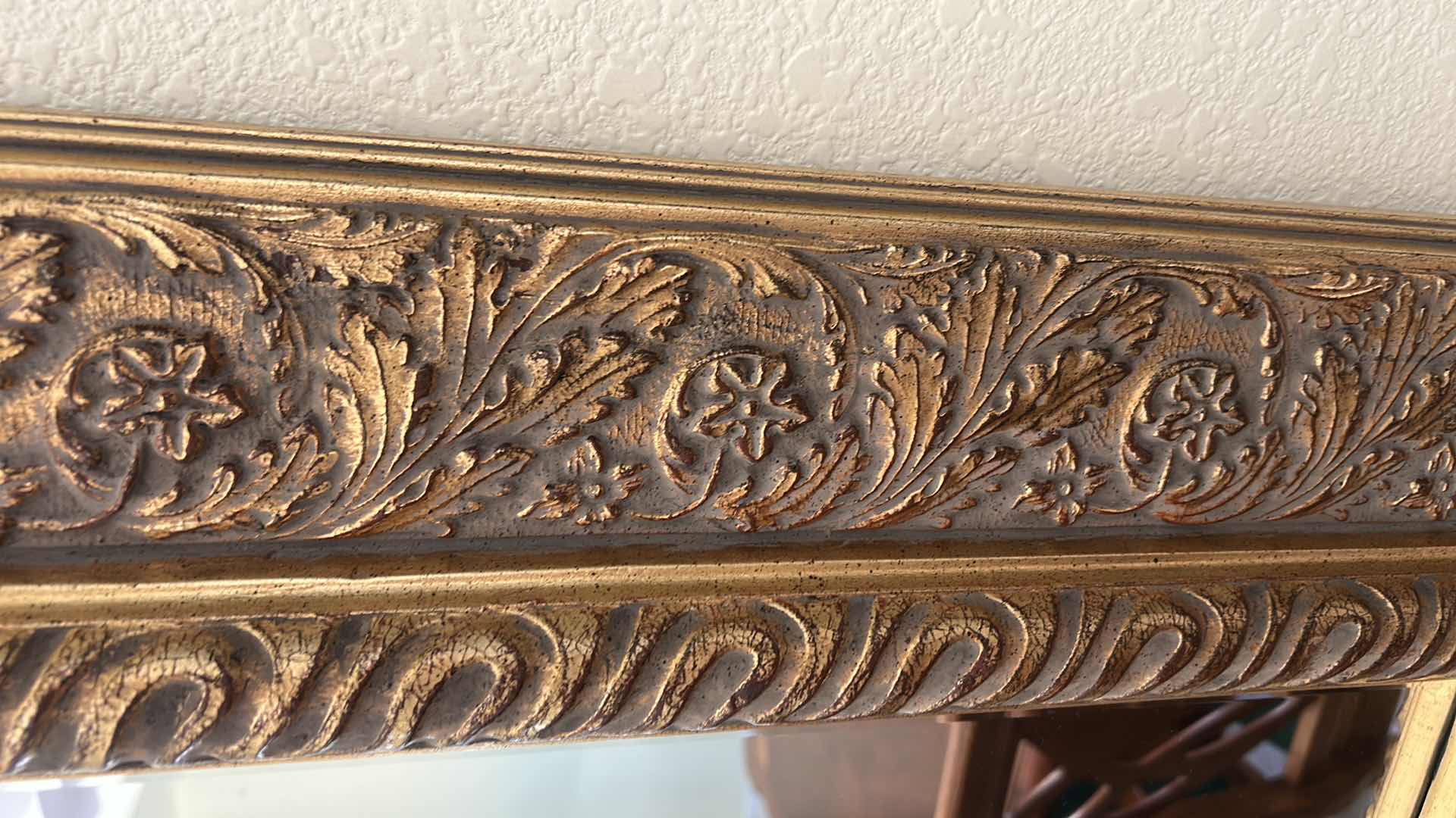 Photo 1 of VINTAGE-STYLE RECTANGULAR BEVELED MIRROR FEATURING A LARGE WOOD GOLD GILT FRAME WITH ORNATE FLORAL AND VINE CARVINGS. 49 1/2“ x 41“.