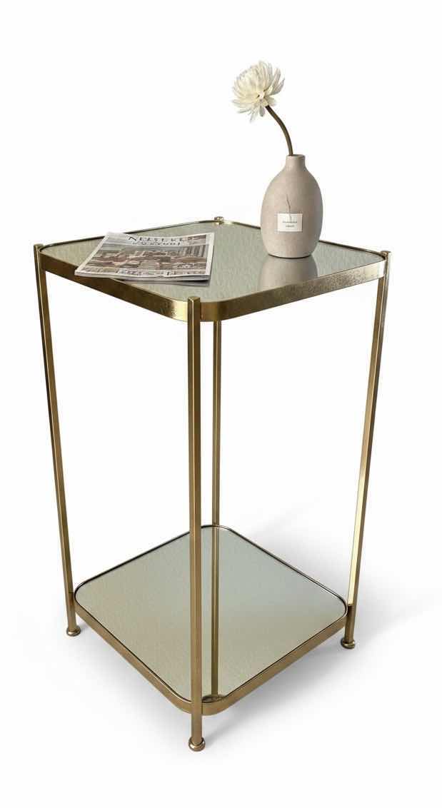 Photo 1 of VINTAGE GOLD METAL SIDE TABLE FEATURING A DECORATIVE FRAME AND GLASS SHELVES. 12“ x 12“ x H25 1/2“