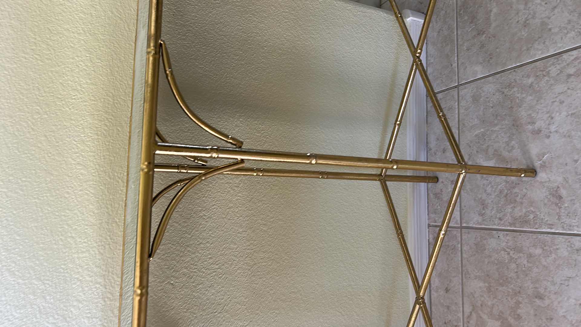 Photo 1 of VINTAGE GOLD BAMBOO-STYLE CONSOLE TABLE FEATURING A GLASS TOP AND AN ELEGANT GOLD-FINISHED METAL FRAME DESIGNED TO RESEMBLE BAMBOO 40“ x 10 1/2“ x H29“.
