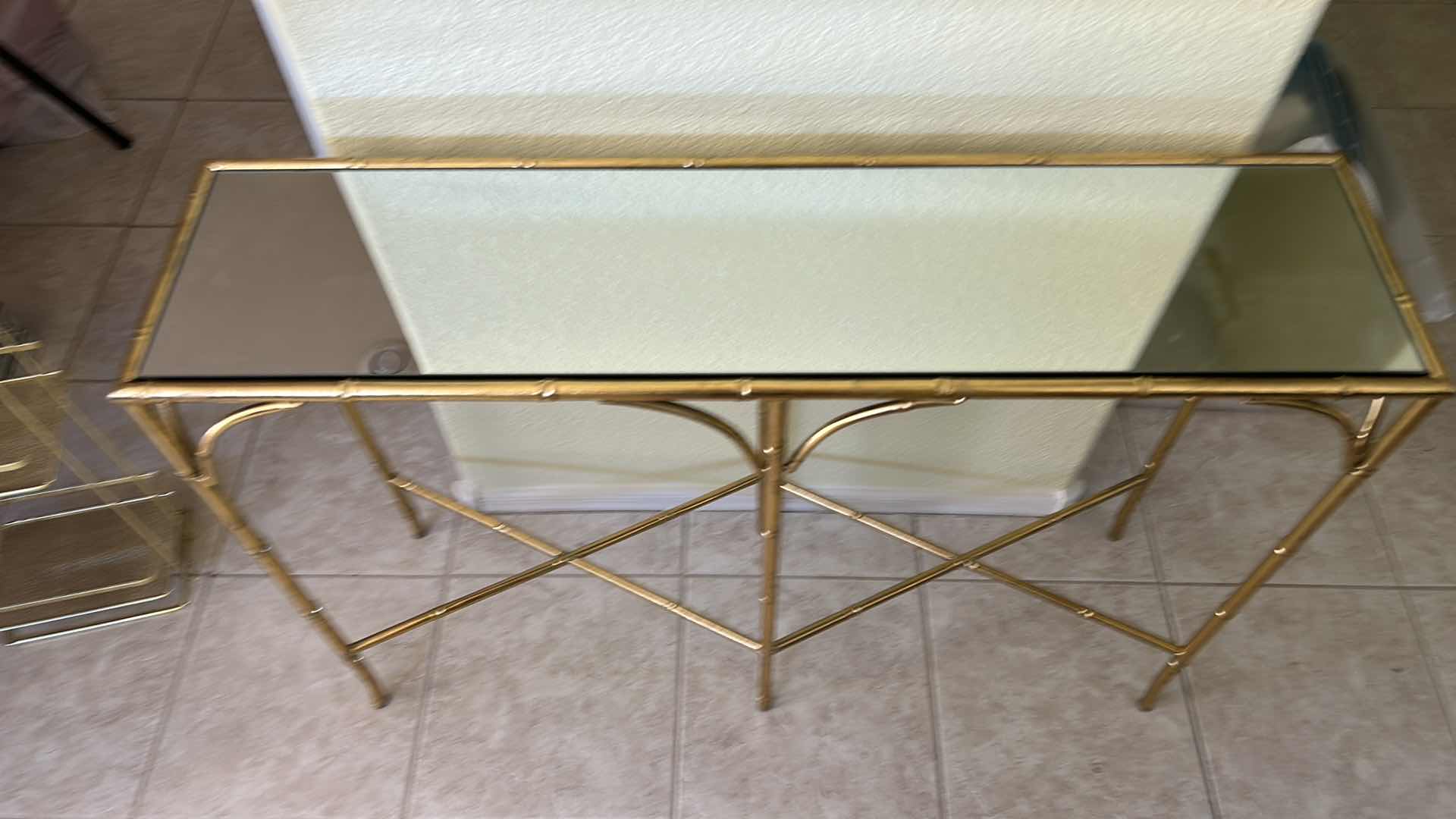 Photo 1 of VINTAGE GOLD BAMBOO-STYLE CONSOLE TABLE FEATURING A GLASS TOP AND AN ELEGANT GOLD-FINISHED METAL FRAME DESIGNED TO RESEMBLE BAMBOO 40“ x 10 1/2“ x H29“.