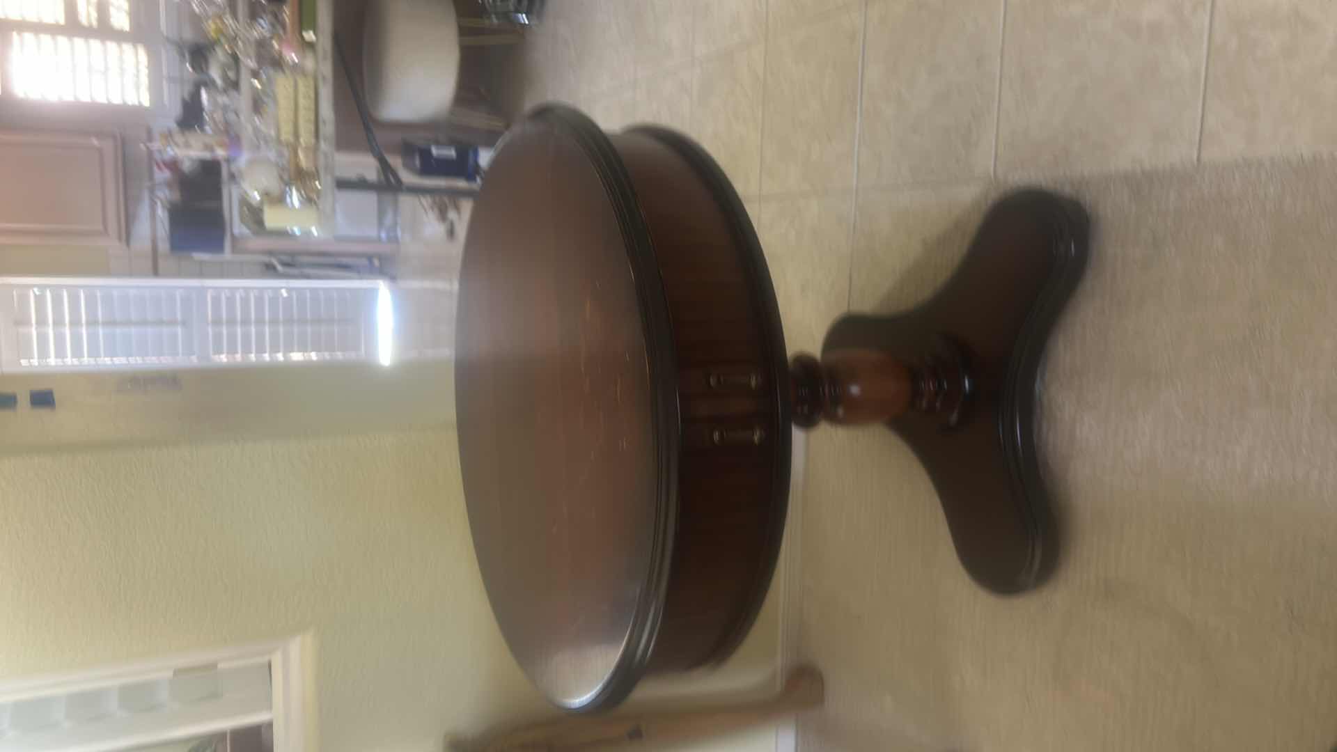 Photo 1 of BUTLER SPECIALTY COMPANY ELLSWORTH FOYER TABLE FEATURING A ROUND TOP, RIBBED CYLINDRICAL CABINET BASE, AND INTERIOR STORAGE COMPARTMENT. 29 1/4“ x 29 1/2“.