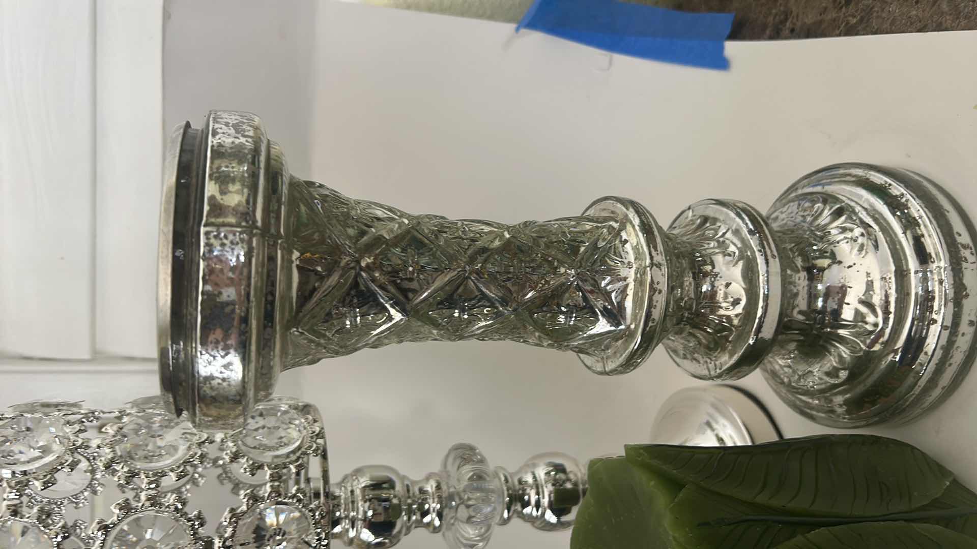 Photo 1 of THREE SILVER TONE CANDLE HOLDERS AND TWO DECORATIVE CANDLES. (TALLEST 16”)