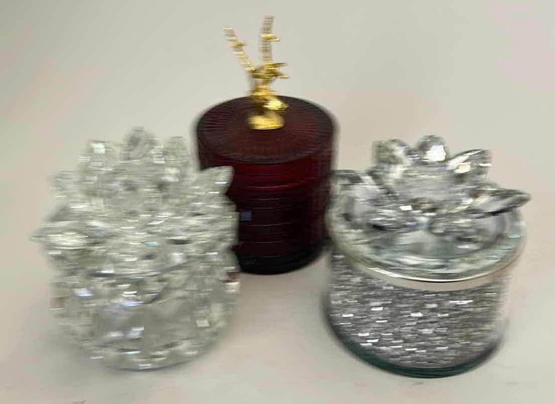 Photo 1 of SAGEBROOK HOME DECORATIVE BOXES FEATURE CRYSTAL LOTUS FLOWER LIDS AND GLITTER-FILLED OR FACETED GLASS BODIES FOR STORING SMALL TREASURES & RUBY-COLORED LVD GLASS TRINKET BOX FEATURES A DISTINCTIVE GOLD REINDEER TOPPER. $125