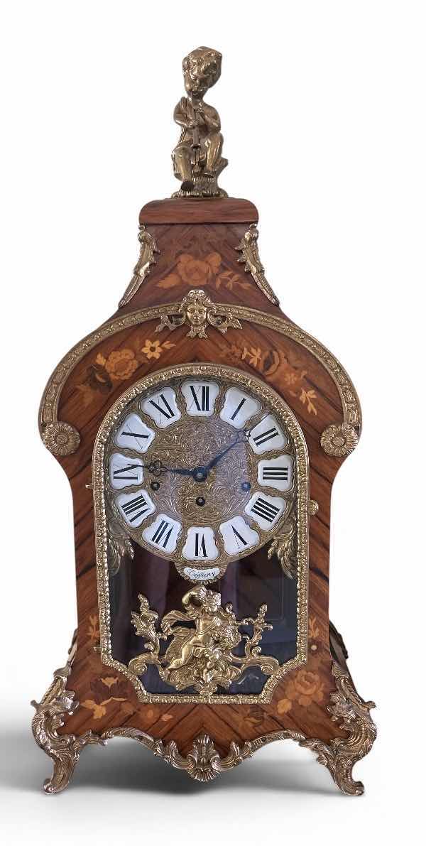 Photo 1 of TIFFANY MADE IN ITALY - FRENCH STYLE VERSAILLES CLOCK FEATURES AN ORNATE GILDED METAL CASE WITH ELABORATE SCROLLWORK, FLORAL MOTIFS, AND A DECORATIVE FINIAL. MATCHING PEDESTAL 14 1/2“ x 6 1/4“ x H31“ PEDESTAL16 1/2” x 9 1/2” x H 44 1/2” TOTAL HEIGHT, INCL