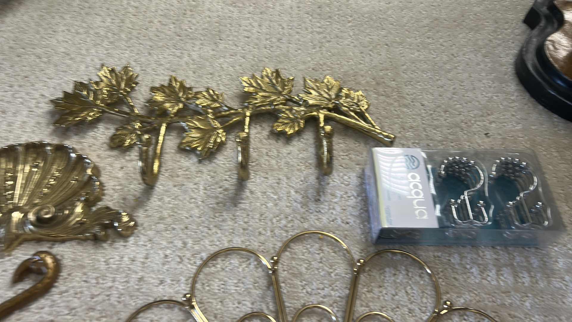 Photo 1 of GOLD-COLORED METAL WALL RACKS FEATURING HOOKS FOR ORGANIZING ITEMS.