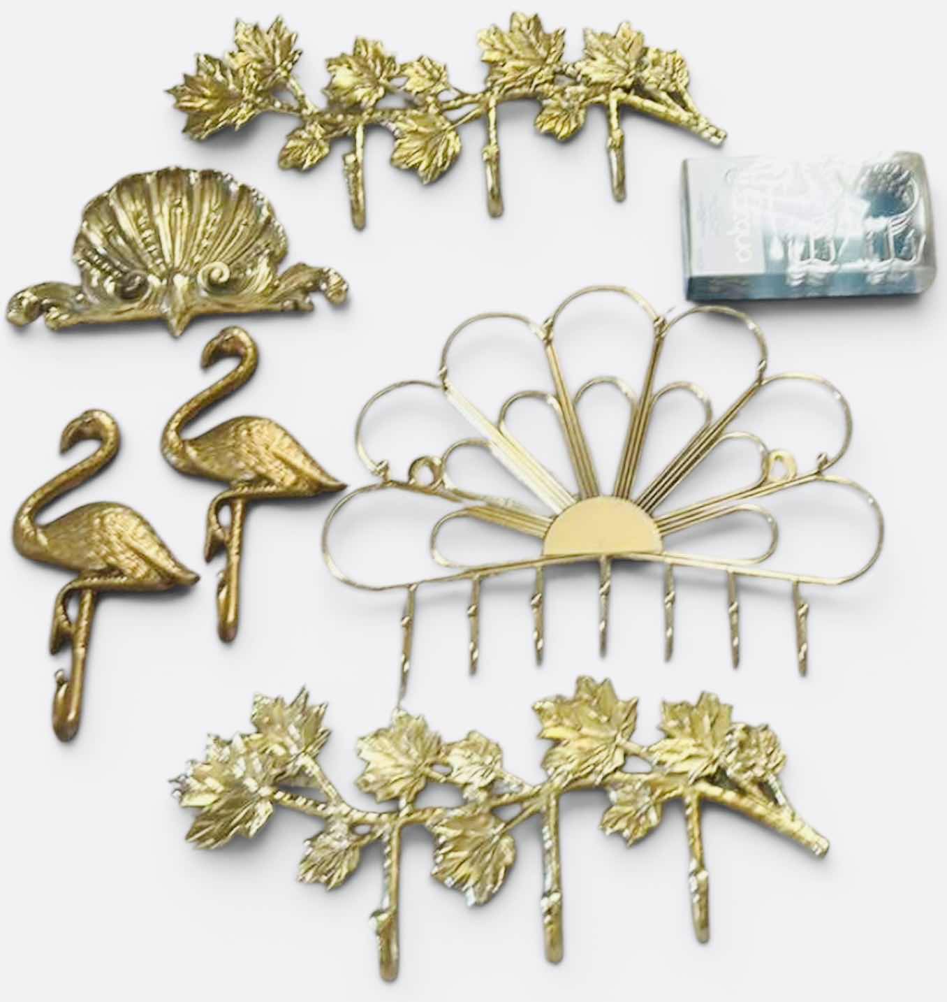 Photo 1 of GOLD-COLORED METAL WALL RACKS FEATURING HOOKS FOR ORGANIZING ITEMS.