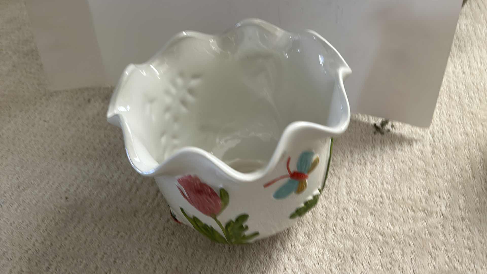 Photo 1 of WHITE CERAMIC PLANTER ARTWARE FEATURING A COLORFUL, HAND-PAINTED BUTTERFLY AND FLORAL DESIGN.
10” x H9”