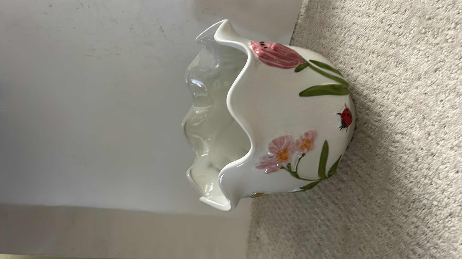 Photo 1 of WHITE CERAMIC PLANTER ARTWARE FEATURING A COLORFUL, HAND-PAINTED BUTTERFLY AND FLORAL DESIGN.
10” x H9”