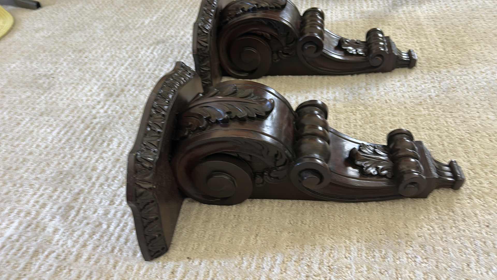 Photo 1 of 2 -MAHOGANY SCONCE CORBELS FEATURE INTRICATE ACANTHUS LEAF CARVINGS AND A RICH, DARK WOOD FINISH. H16” $100