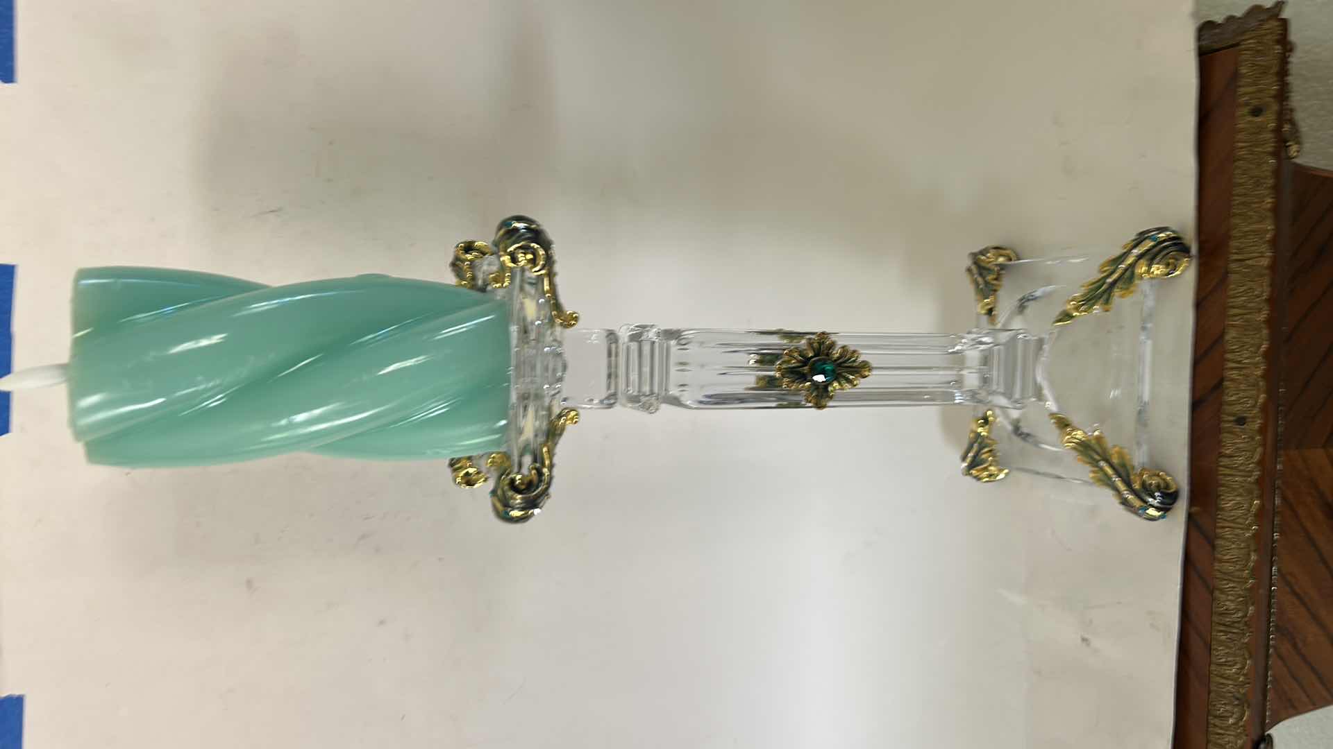Photo 1 of ORNATE BAROQUE-STYLE CRYSTAL CANDLESTICK FEATURES DISTINCTIVE GOLD-LEAF EMBELLISHMENTS AND EMERALD-COLORED JEWEL ACCENTS. H13” & BATTERY OPERATED CANDLE. $125