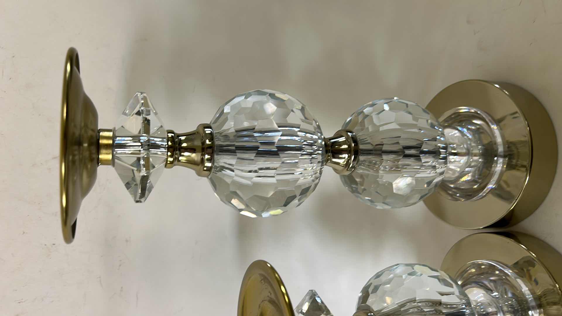 Photo 1 of 2- LOLA GOLD PILLAR CANDLEHOLDERS FROM TOUCH OF CLASS FEATURE FACETED CRYSTAL ACCENTS AND A POLISHED GOLD-FINISHED METAL BASE. (TALLEST H12”) $150
