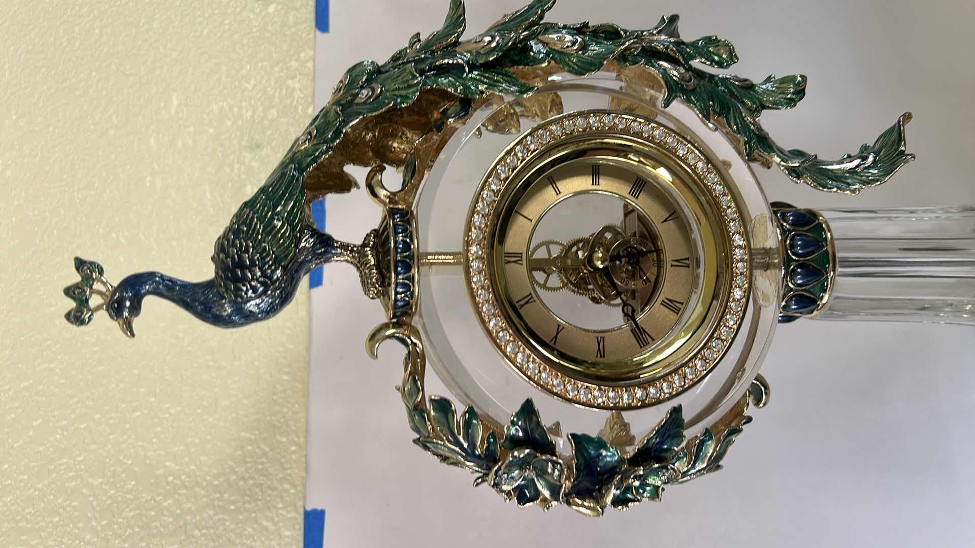 Photo 1 of REGIS GALERIE PEACOCK CRYSTAL CLOCK FEATURES AN ORNATE, ENAMELED PEACOCK FIGURE PERCHED ATOP A CLEAR CRYSTAL STAND H 24”