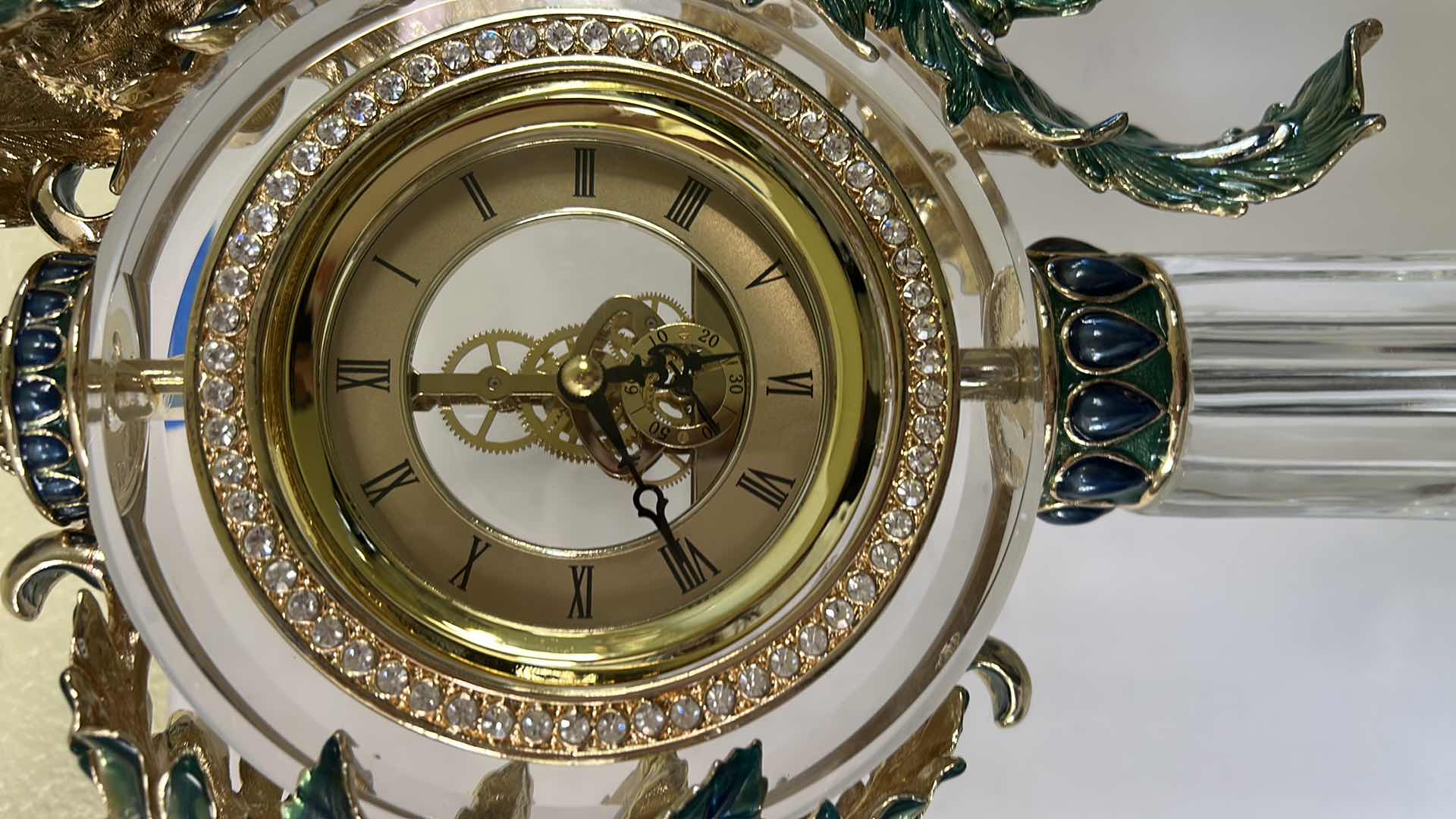 Photo 1 of REGIS GALERIE PEACOCK CRYSTAL CLOCK FEATURES AN ORNATE, ENAMELED PEACOCK FIGURE PERCHED ATOP A CLEAR CRYSTAL STAND H 24”
