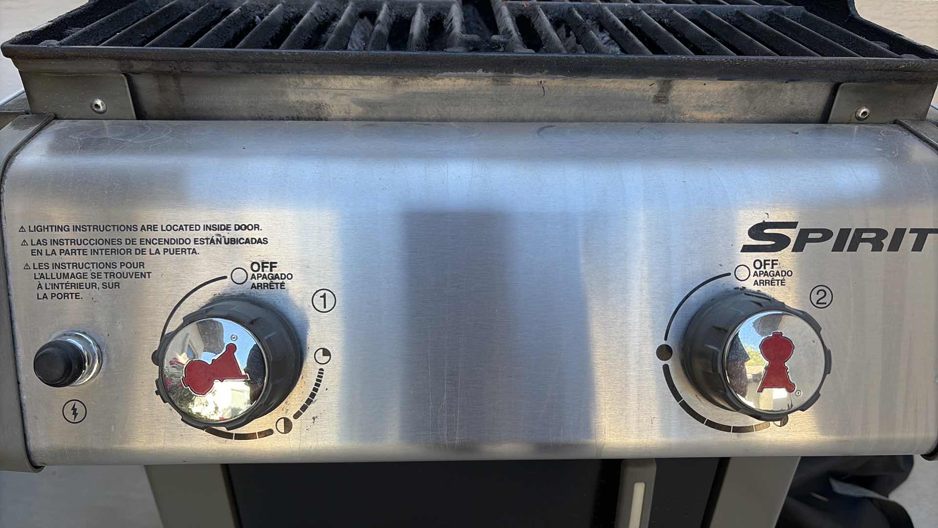 Photo 1 of WEBER SPIRIT 2-BURNER PROPANE GAS GRILL WITH SIDE SHELVES, ENCLOSED STORAGE CABINET, BUILT-IN LID THERMOMETER, AND ROLLING CART W COVER 50”X21”H45”