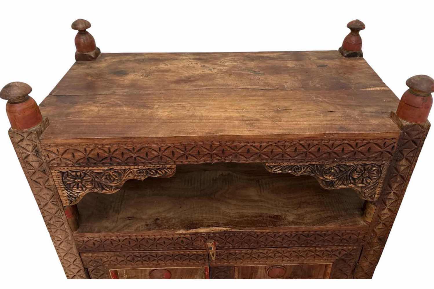 Photo 1 of HAND-CARVED WOOD ACCENT CABINET W/OPEN SHELF, TWO DOORS, INTERIOR STORAGE, AND DISTRESSED PAINTED ACCENTS 32”X16.5”H45”