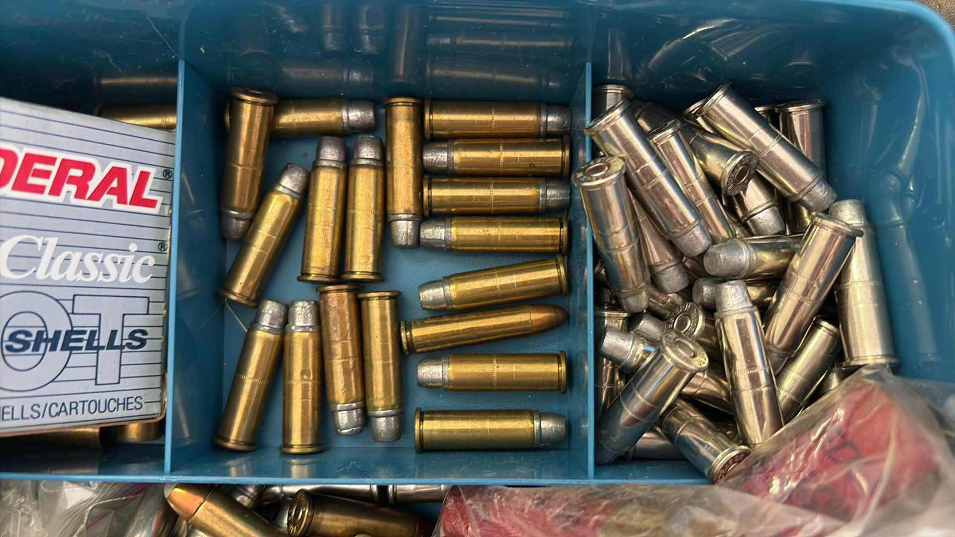 Photo 1 of SMALL PLASTIC CONTAINER FULL OF LOOSE AMMUNITION