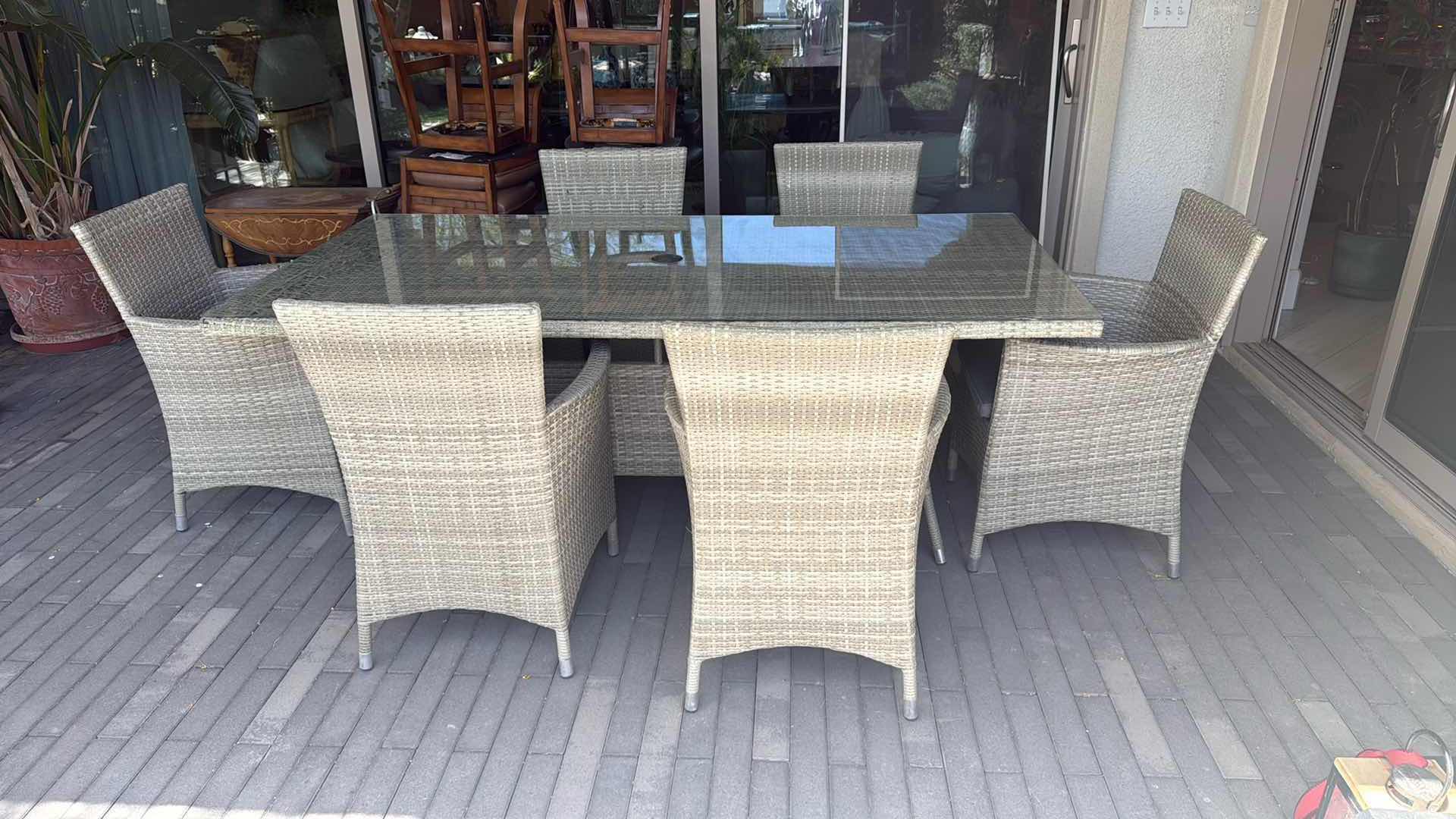 Photo 1 of WICKER PATIO LIGHT GRAY TABLE W GLASS TOP PROTECTOR & 6 ARM CHAIRS 79” x 40” H29” (SEE NOTES)