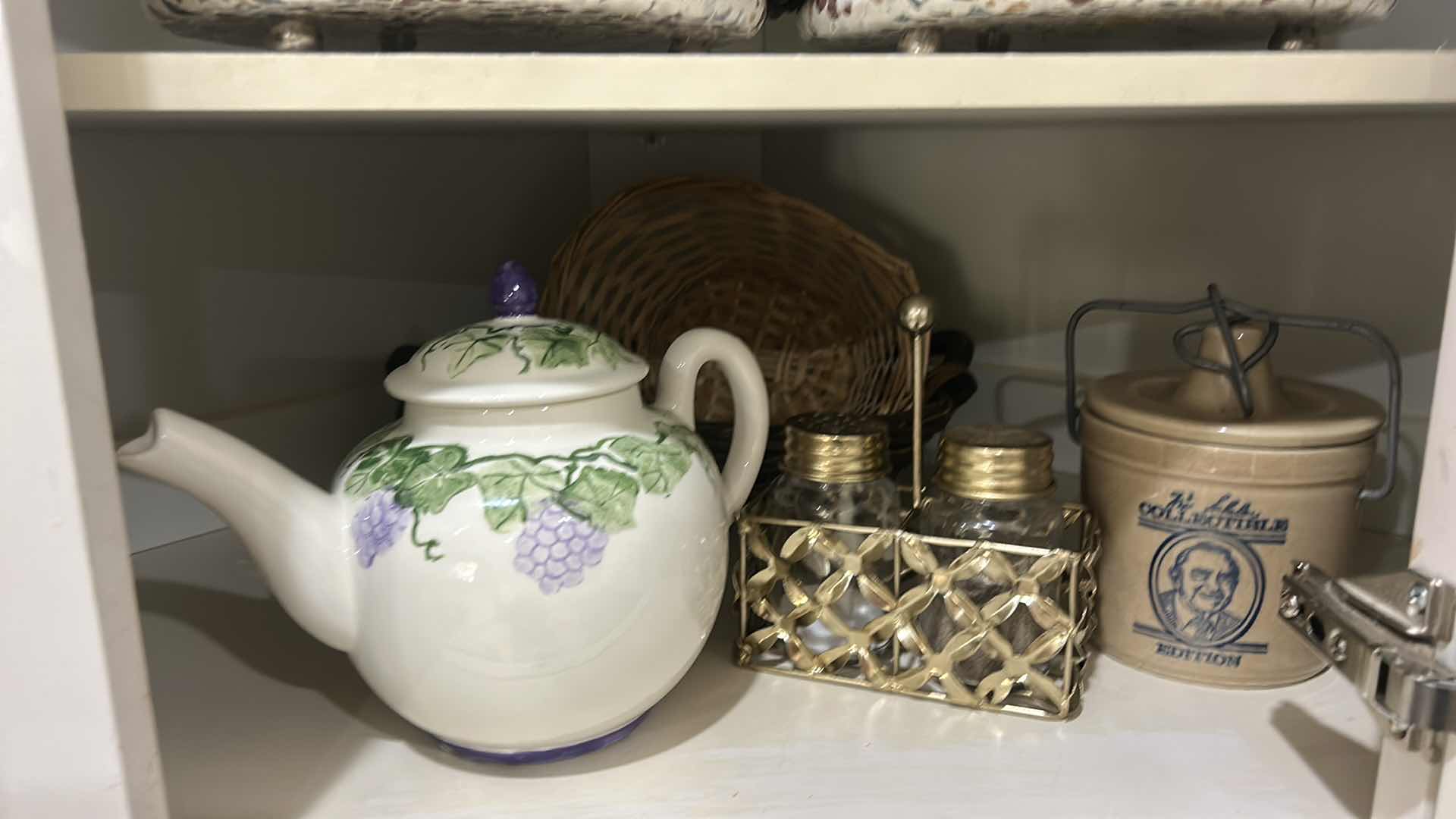 Photo 1 of CONTENTS OF CABINET IN KITCHEN, CANISTER, TEA, POT, TRIVETS, AND MORE