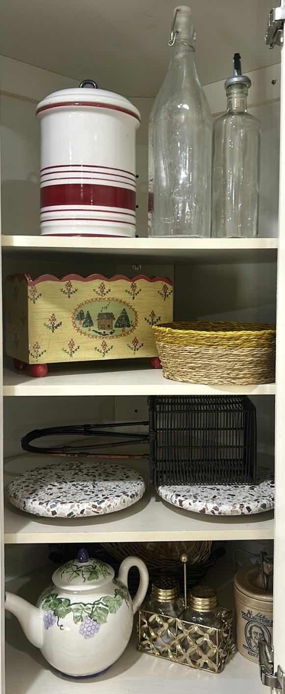Photo 1 of CONTENTS OF CABINET IN KITCHEN, CANISTER, TEA, POT, TRIVETS, AND MORE
