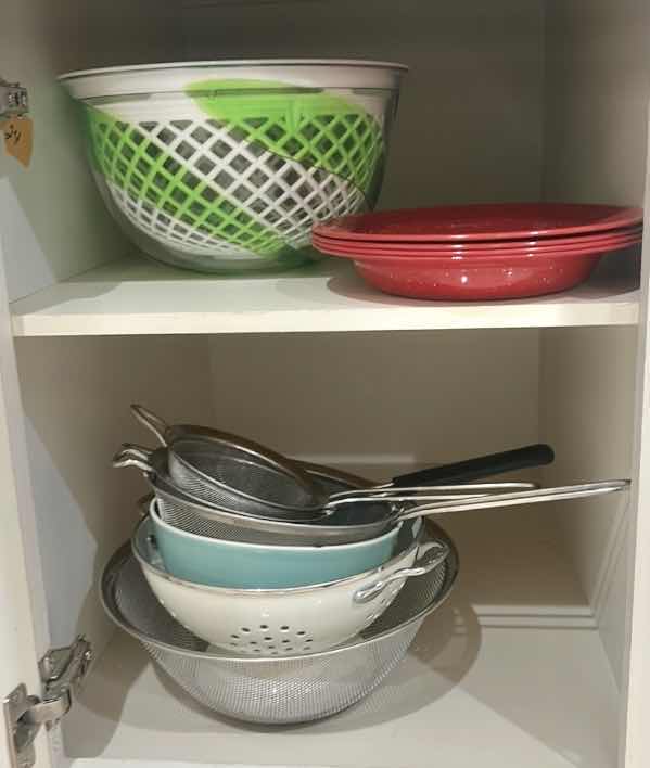 Photo 1 of CONTENTS OF CABINET IN KITCHEN PLATES, SALAD, SPINNER, COLANDERS, AND MORE