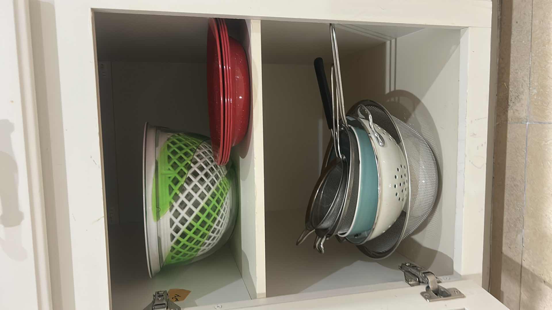 Photo 1 of CONTENTS OF CABINET IN KITCHEN PLATES, SALAD, SPINNER, COLANDERS, AND MORE