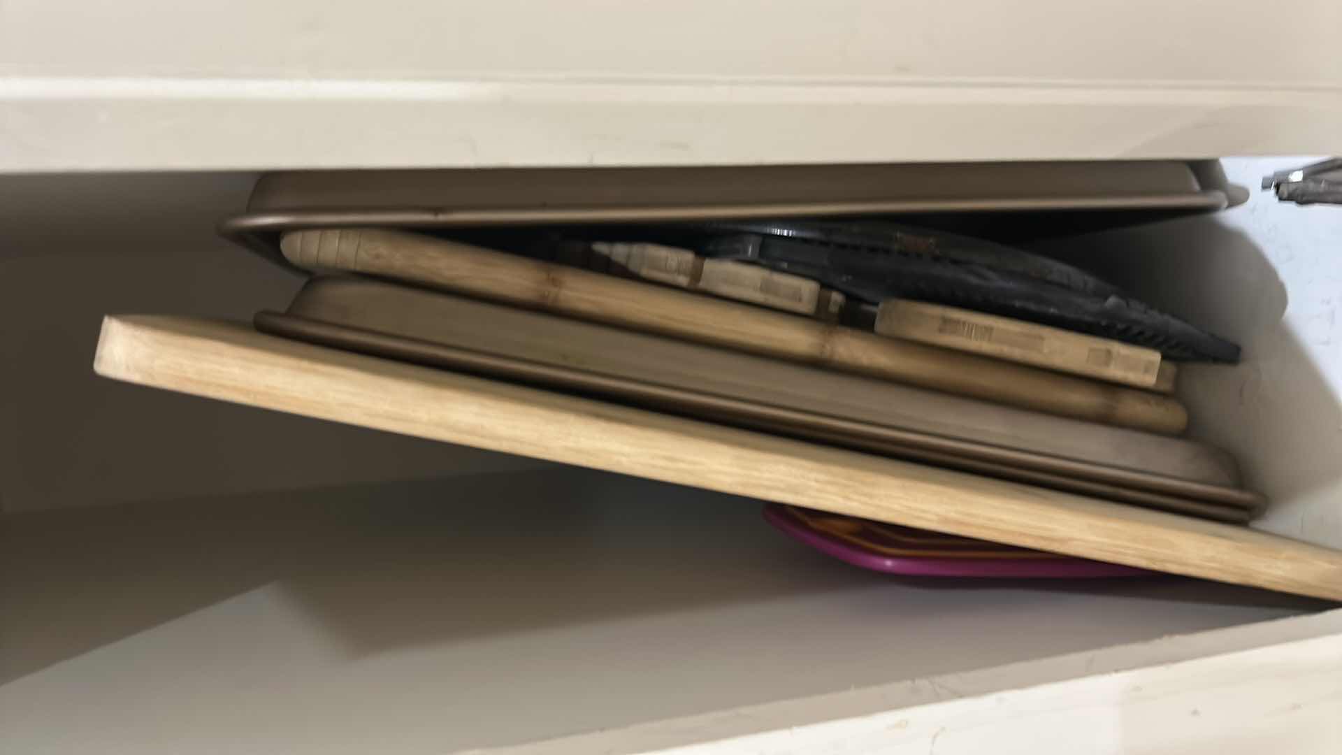 Photo 1 of CONTENTS OF CABINET IN KITCHEN, CUTTING BOARDS BAKING TRAYS