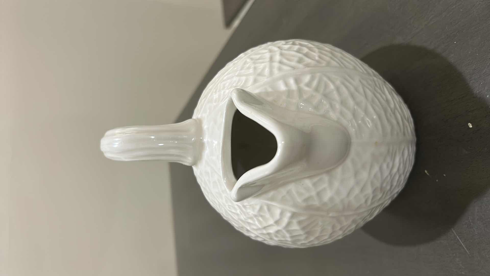 Photo 1 of BLOOMINGDALES WHITE CERAMIC PITCHER IS DESIGNED WITH A UNIQUE TEXTURED REPTILIAN PATTERN REMINISCENT OF A KAISER REPTILE PATTERN VASE.