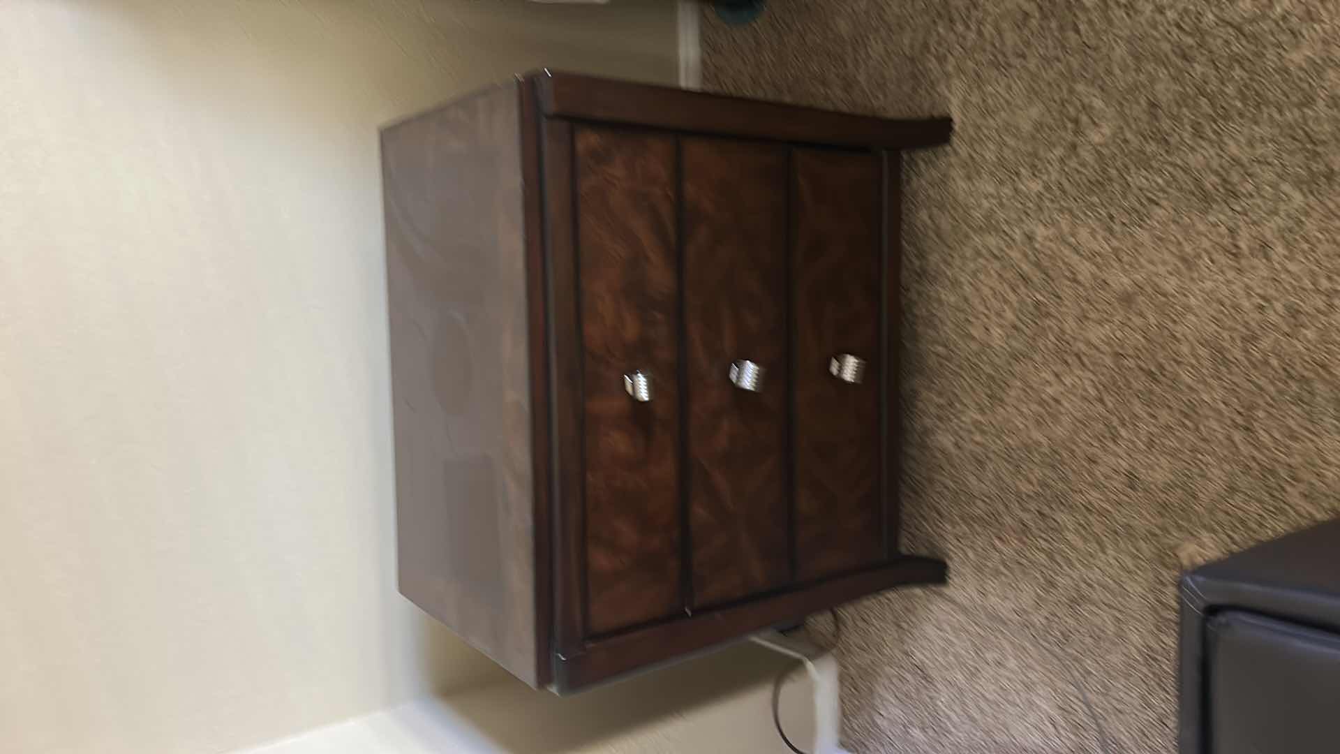 Photo 1 of DARK WOOD THREE-DRAWER NIGHTSTAND W HIGH-GLOSS FINISH BURLED WOOD VENEER DRAWER FRONTS & POLISHED METAL KNOBS.