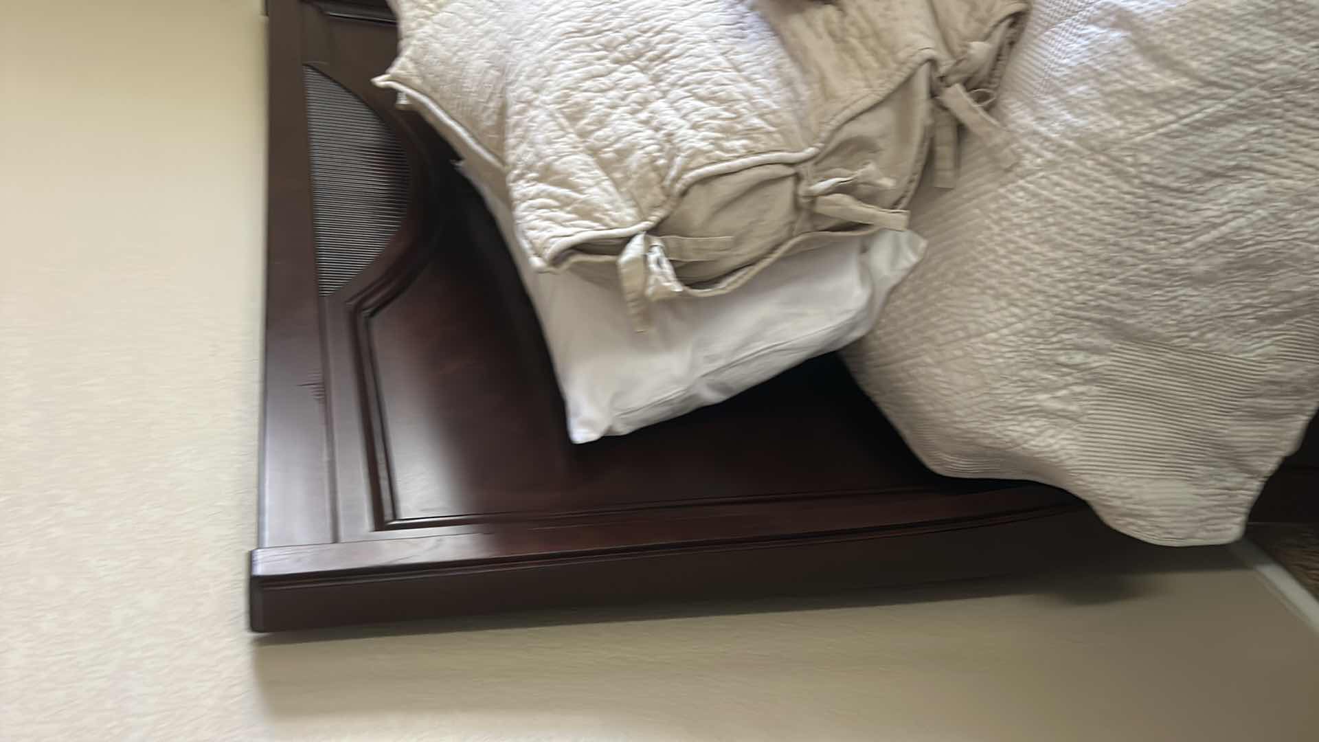 Photo 1 of DARK WOOD PLATFORM BED FEATURING A SLEIGH-STYLE HEADBOARD, MATCHING FOOTBOARD, AND NEUTRAL QUILTED BEDDING WITH ACCENT PILLOWS. INCLUDES SERTA QUEEN MATTRESS. (MATTRESS MEASURES 5 FEET X 81” INCHES HEADBOARD HEIGHT 52 1/2 INCHES)