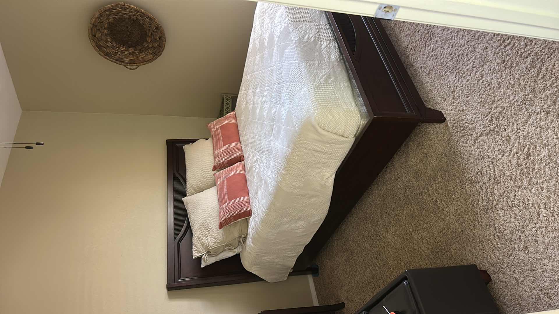 Photo 1 of DARK WOOD PLATFORM BED FEATURING A SLEIGH-STYLE HEADBOARD, MATCHING FOOTBOARD, AND NEUTRAL QUILTED BEDDING WITH ACCENT PILLOWS. INCLUDES SERTA QUEEN MATTRESS. (MATTRESS MEASURES 5 FEET X 81” INCHES HEADBOARD HEIGHT 52 1/2 INCHES)