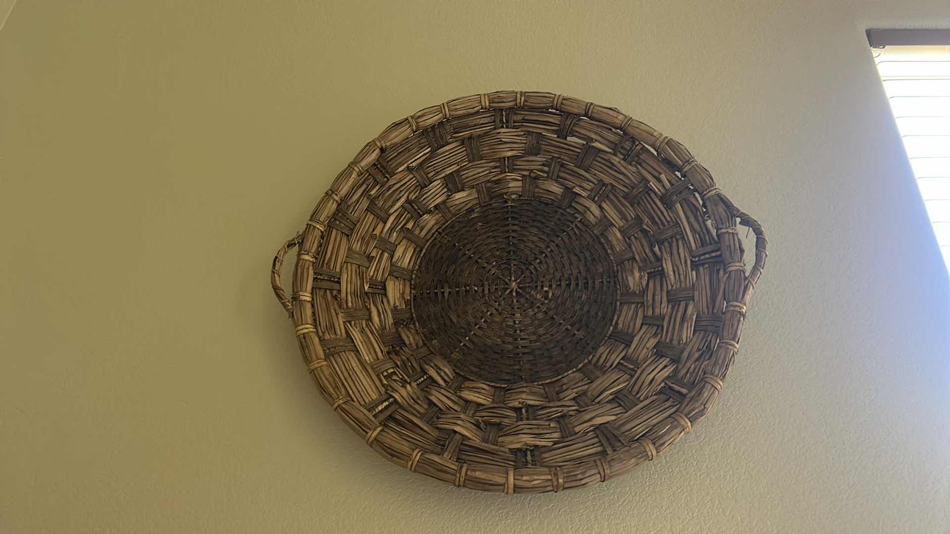 Photo 1 of HAND-WOVEN WICKER BASKET FEATURES DISTINCTIVE EAR HANDLES AND A DURABLE, RUSTIC CONSTRUCTION. 27” ROUND $80