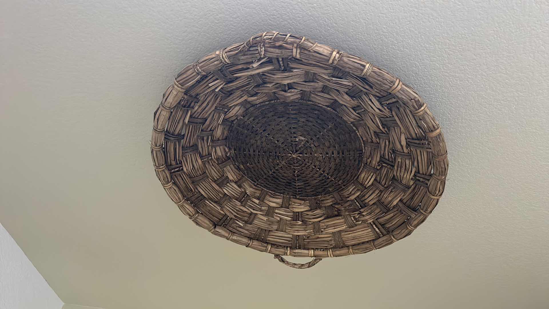 Photo 1 of HAND-WOVEN WICKER BASKET FEATURES DISTINCTIVE EAR HANDLES AND A DURABLE, RUSTIC CONSTRUCTION. 27” ROUND $80