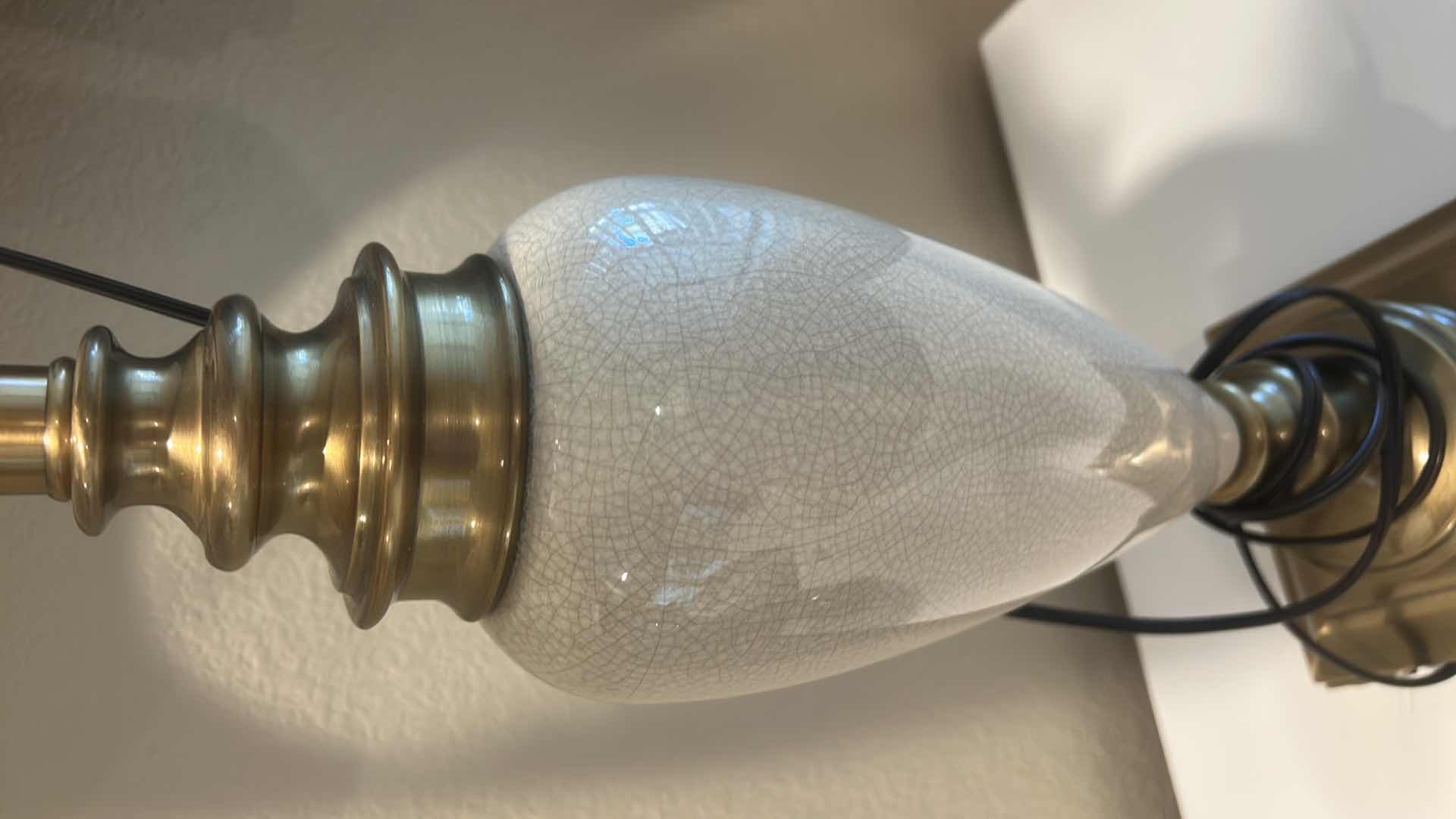 Photo 1 of TABLE LAMP FEATURES A WHITE CERAMIC VASE BODY AND A BOTANICAL PATTERNED SHADE. H34”