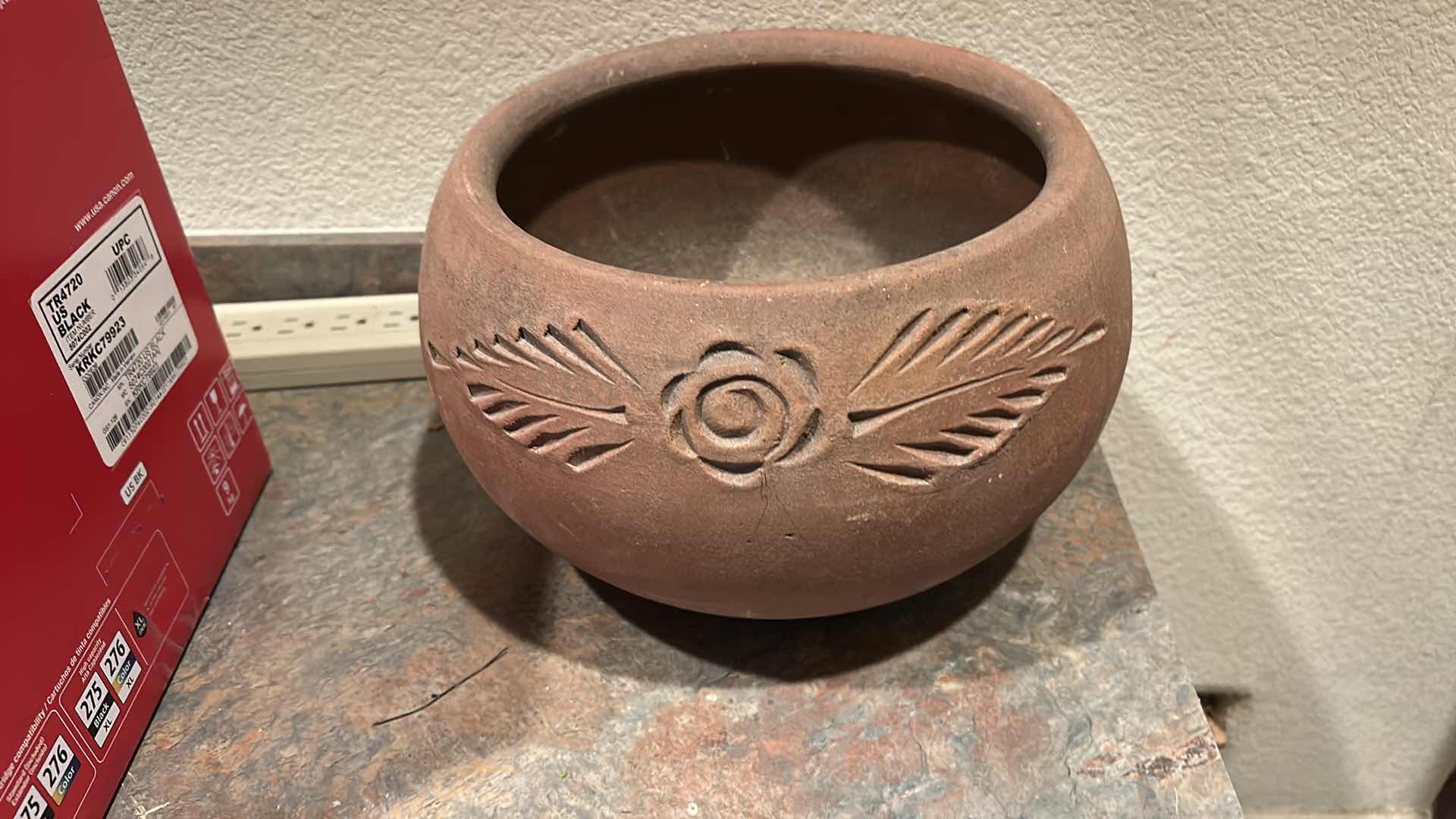 Photo 1 of RUSTICALLY STYLED TERRA COTTA POT FEATURES A HAND-CARVED FLORAL AND LEAF DESIGN. H7.5”